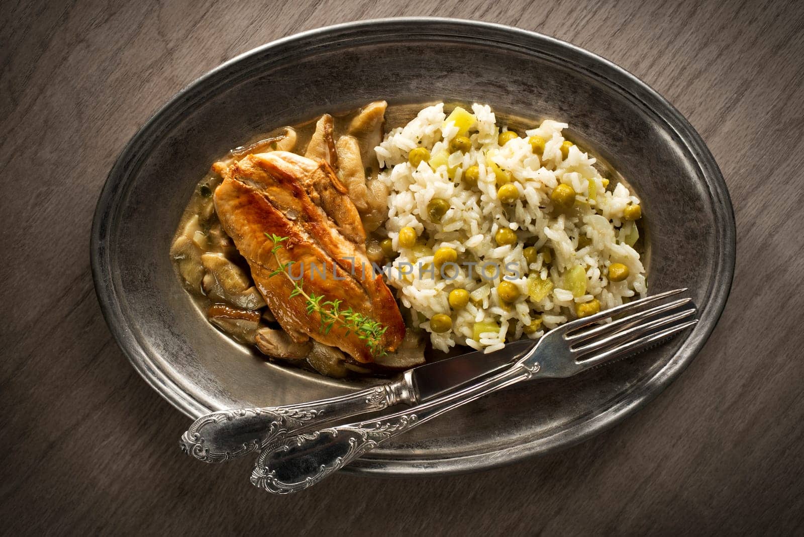 Chicken fillet with mushroom sauce and rice with pea