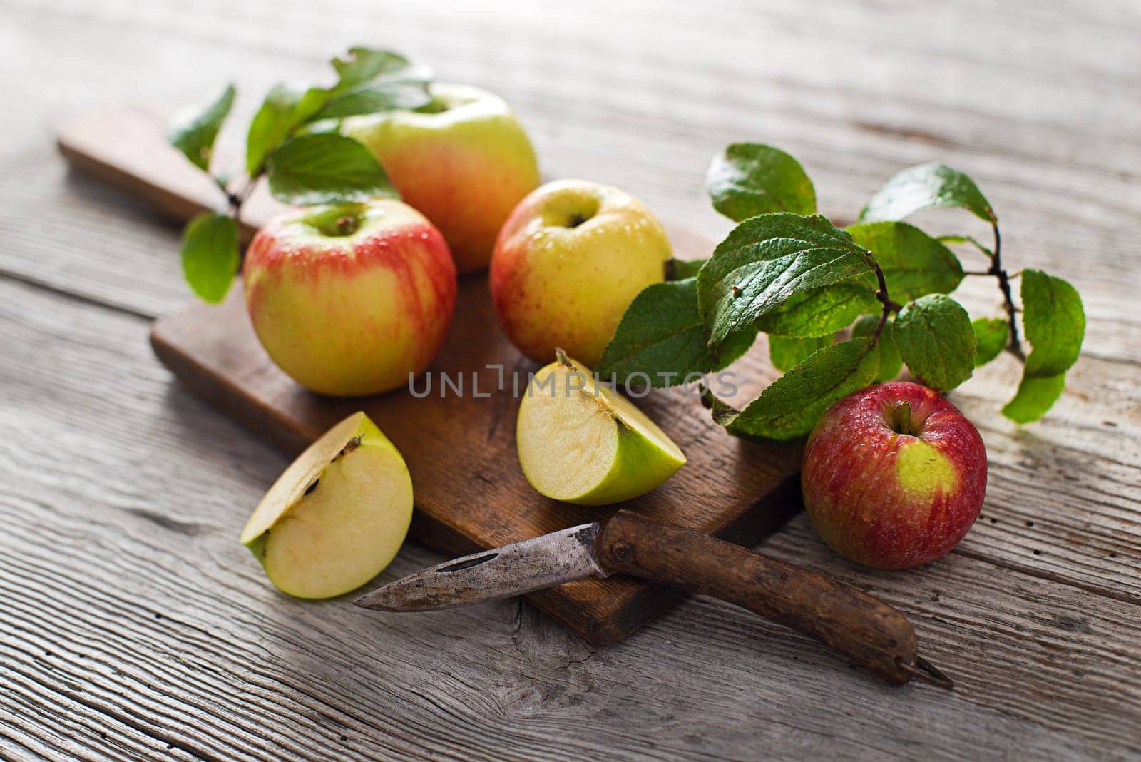 Organic apples on wooden background close up