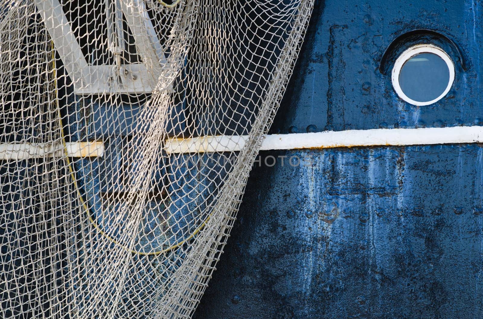 Window of the ship and hanging down networks, close up