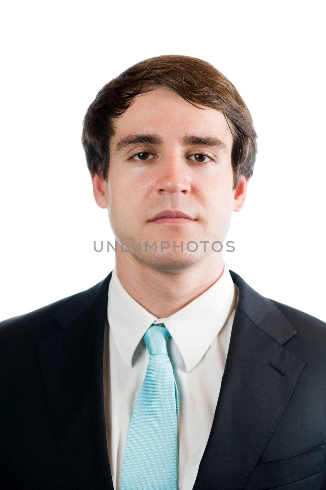 Head-and-shoulder portrait of a young man in a black suit and light blue ties looking into the camera against a white background