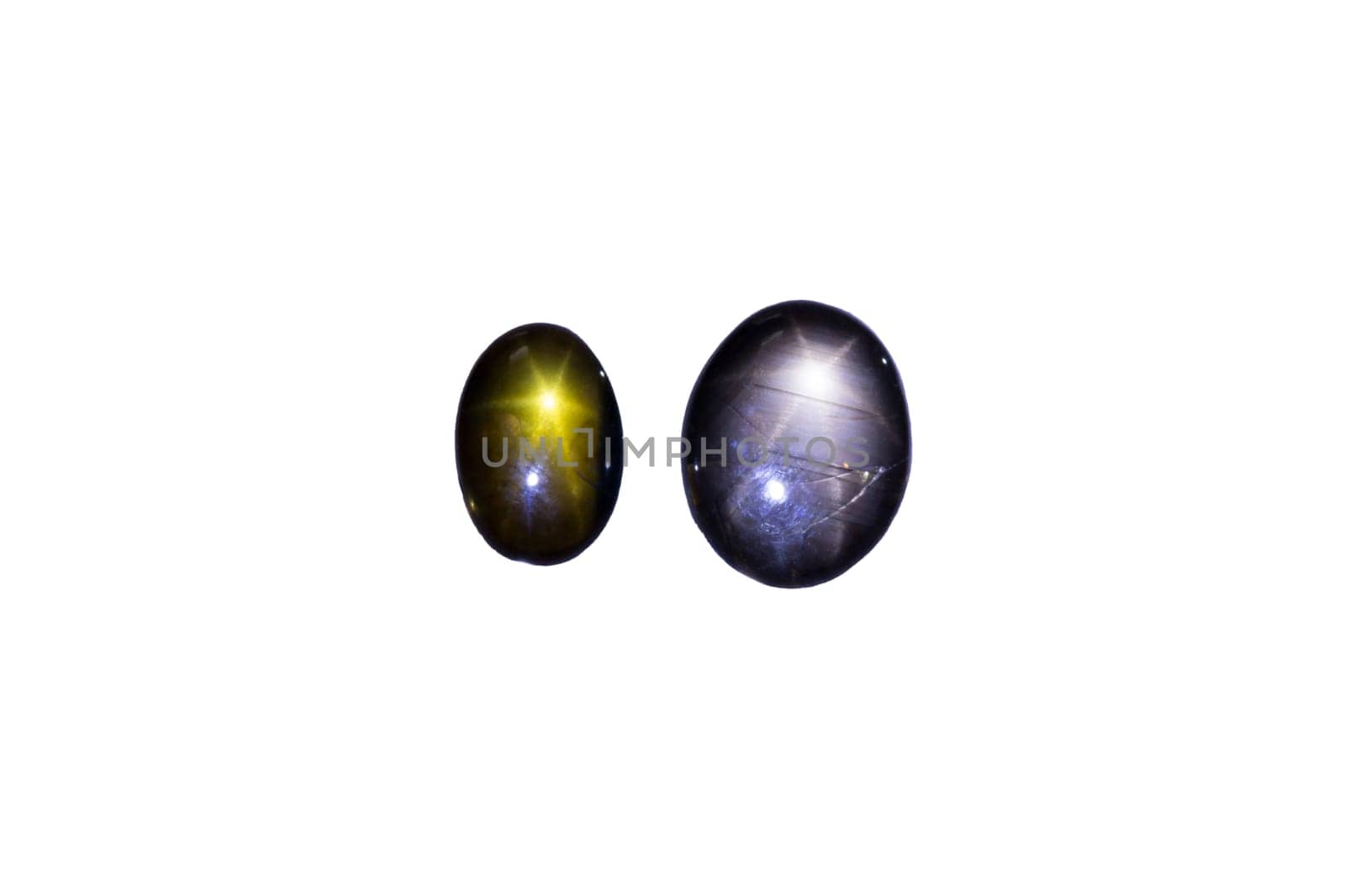 Two sapphires with star-shaped light reflection,cropped