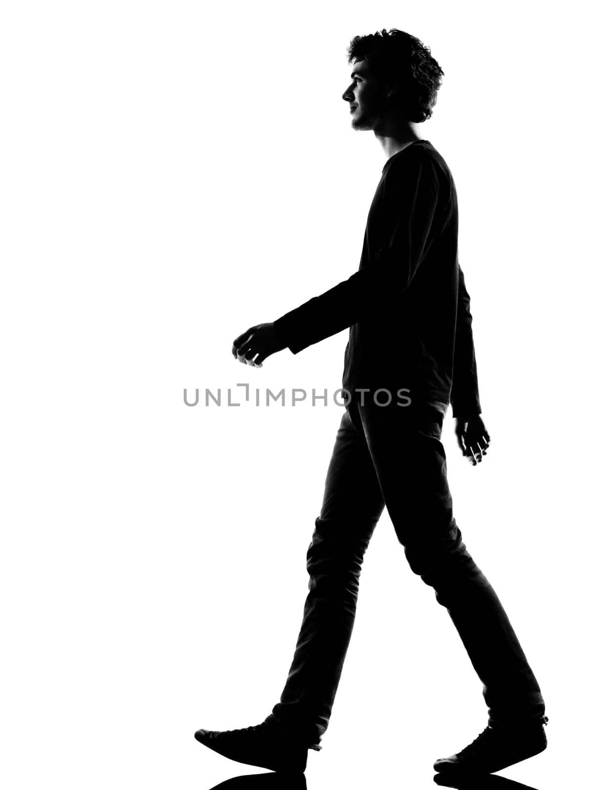 young man sad walking silhouette in studio isolated on white background