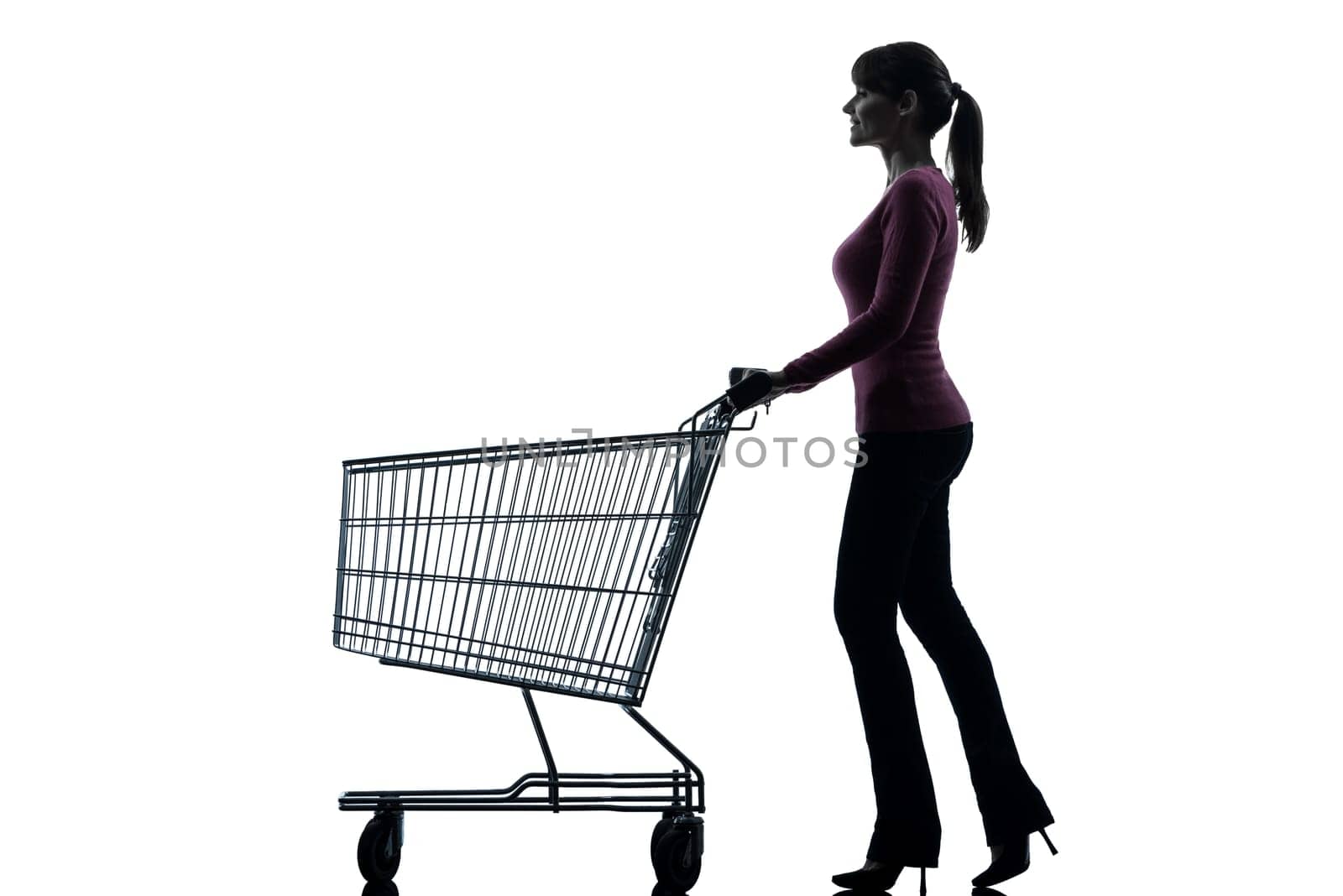 one caucasian woman with empty shopping cart in silhouette studio isolated on white background