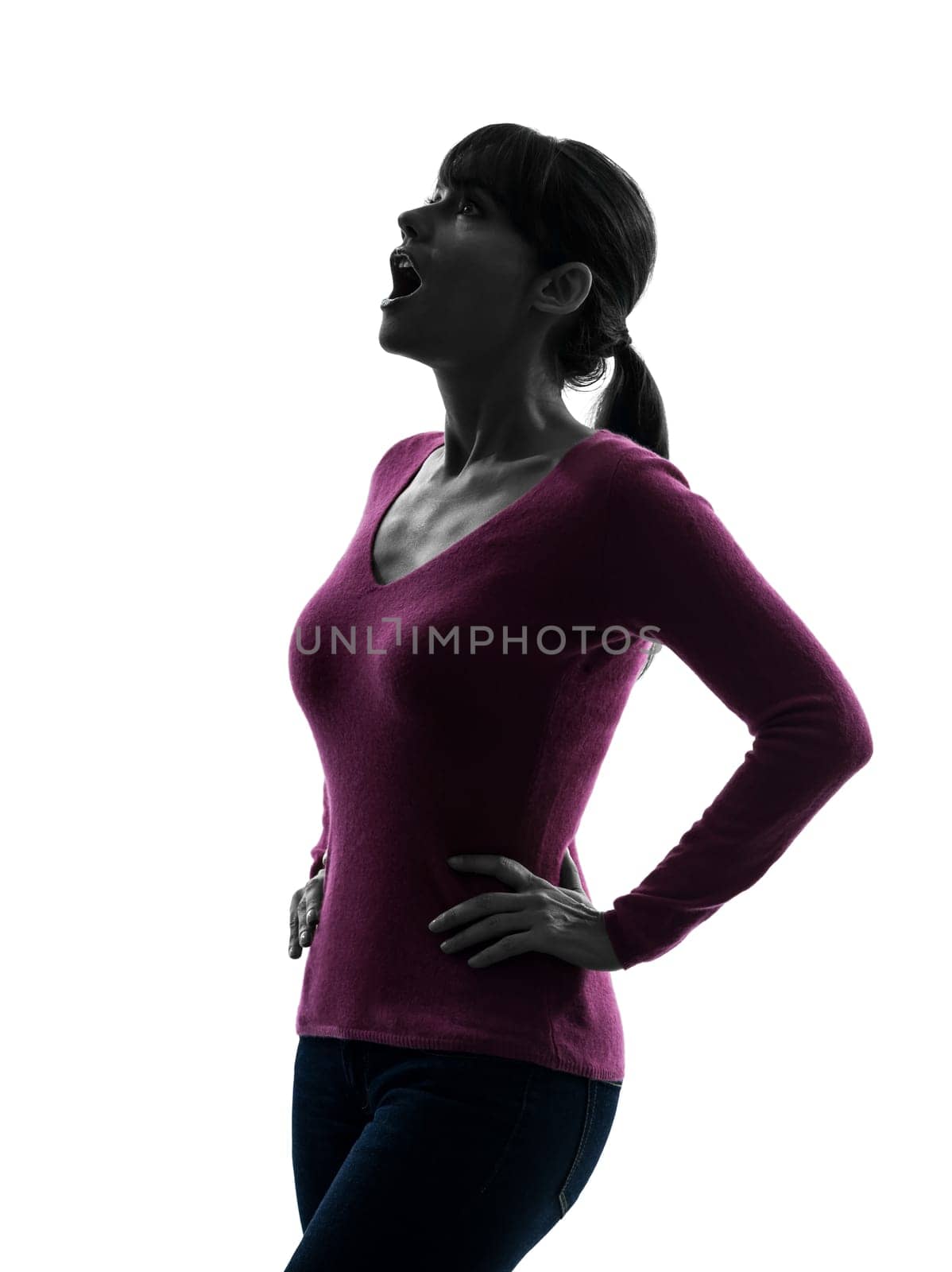 one caucasian woman surprised looking up portrait  in silhouette studio isolated on white background
