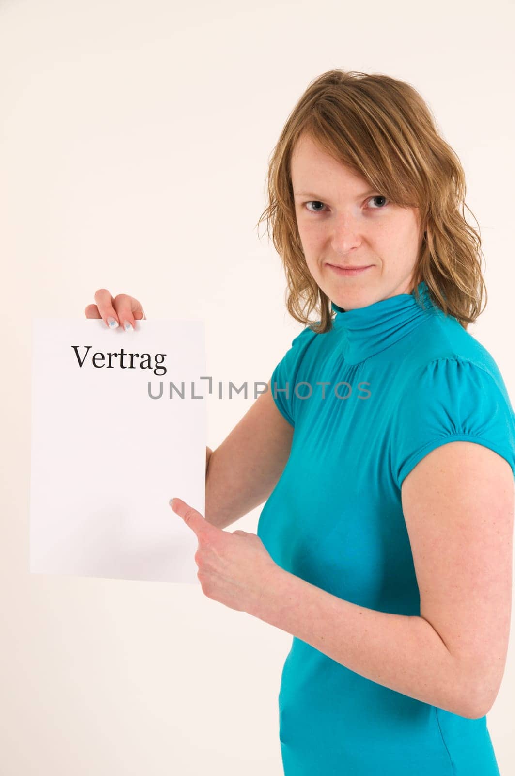 blond woman show with her index finger to the blank contract  young blonde woman points her index finger at an empty contract