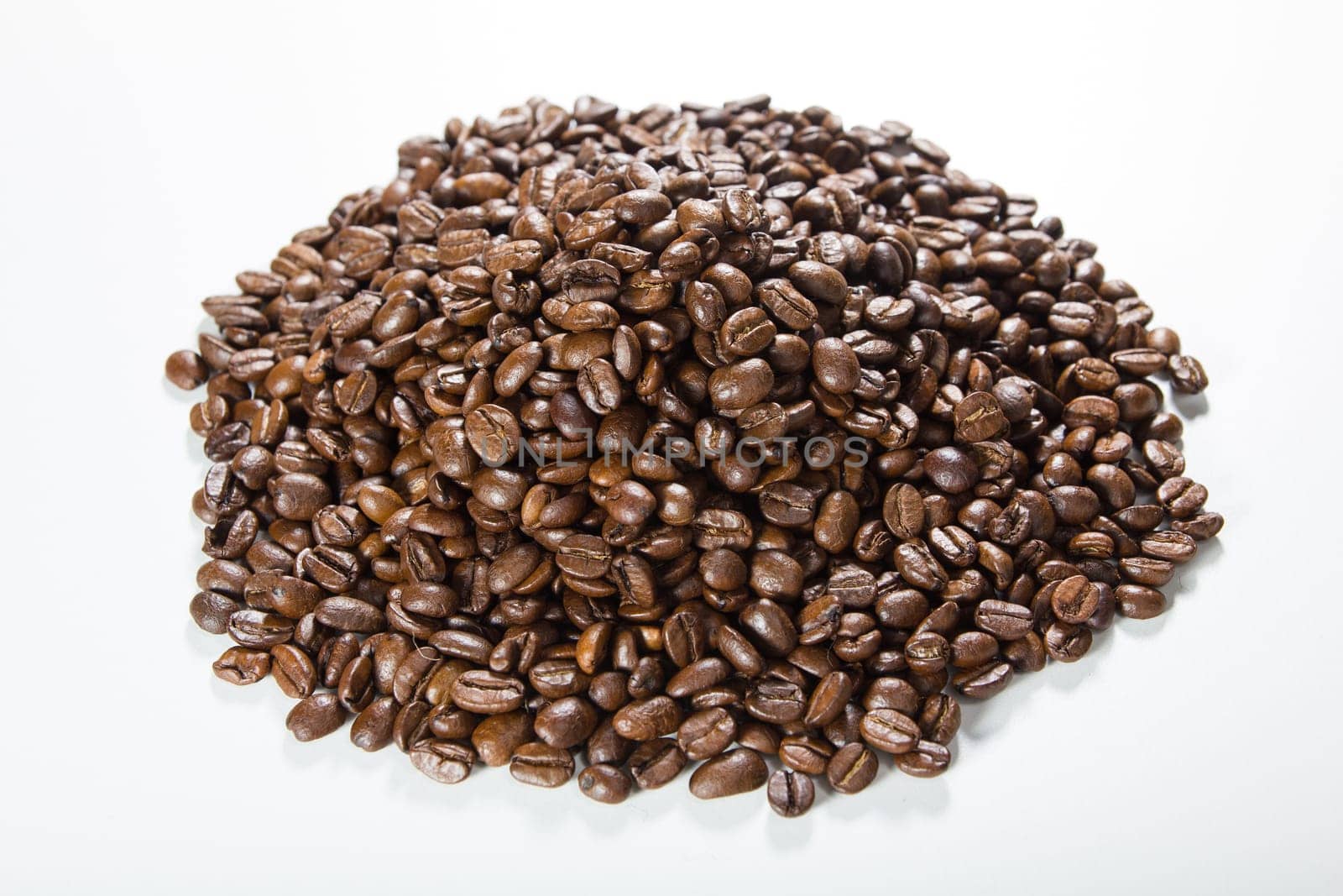 Black roasted coffee beans in a small burlap sack