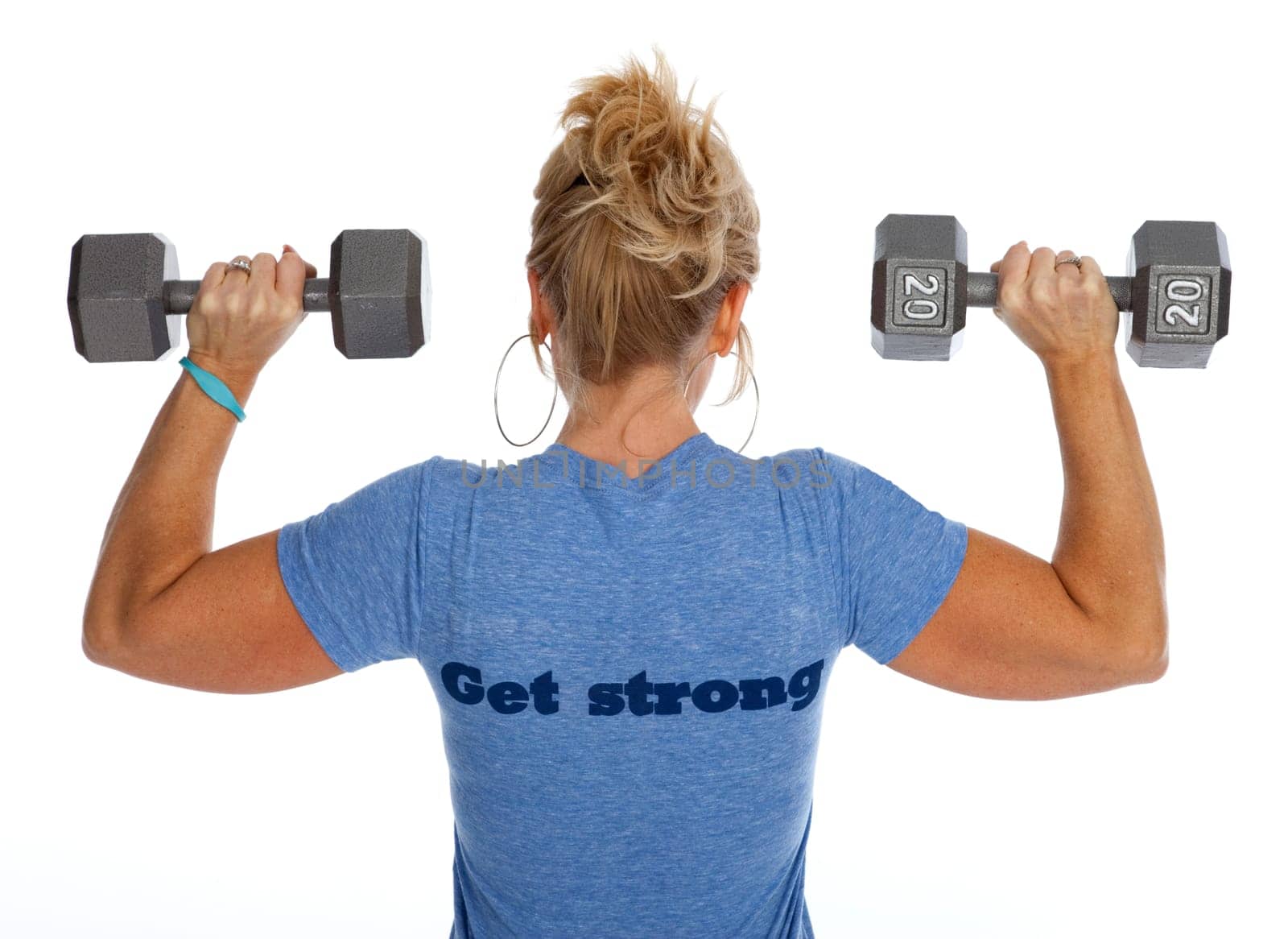 Rear view of woman lifting dumbbells against white background.