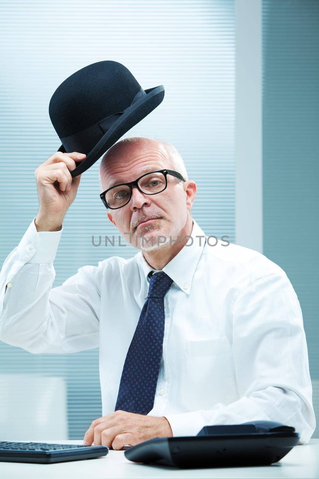 Elegant english businessman with square glasses greeting  with his bowler