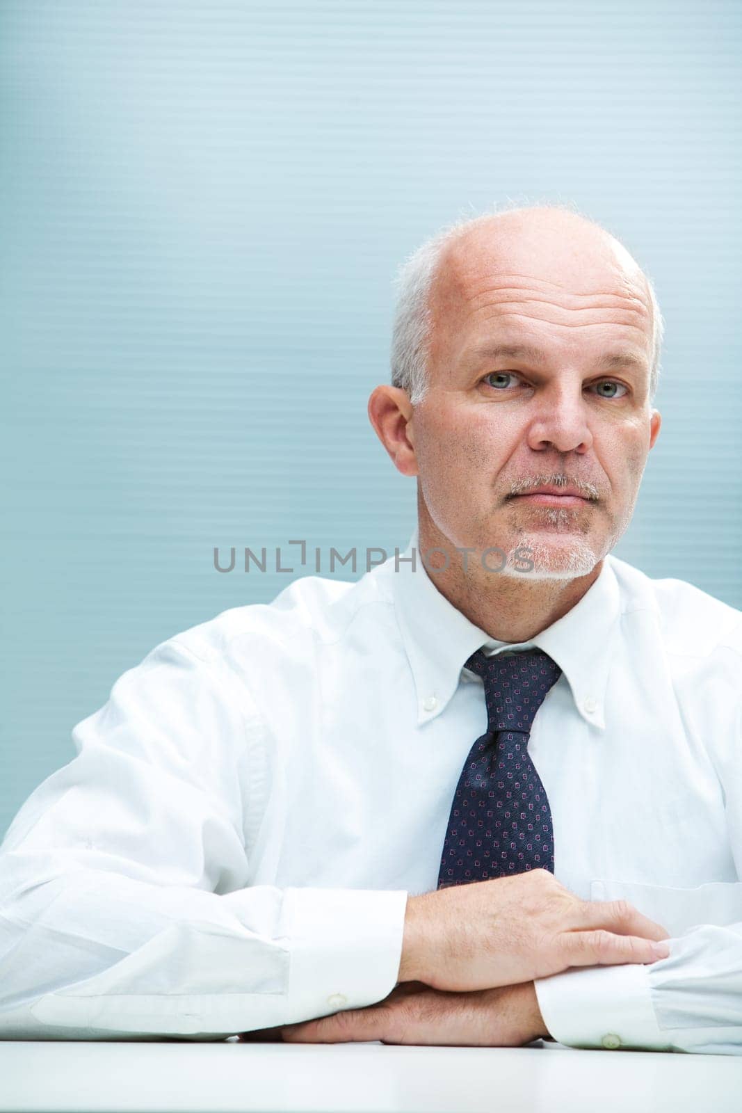 A serious business man staring at camera