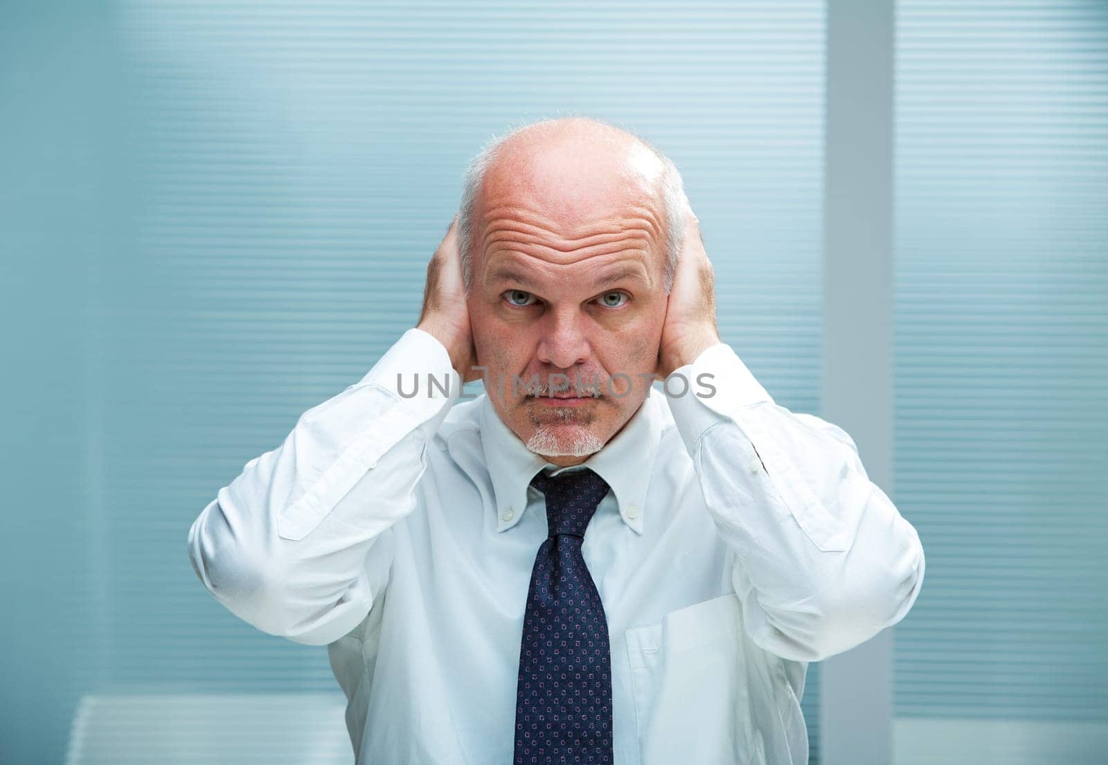 Businessman with the hands on his ears