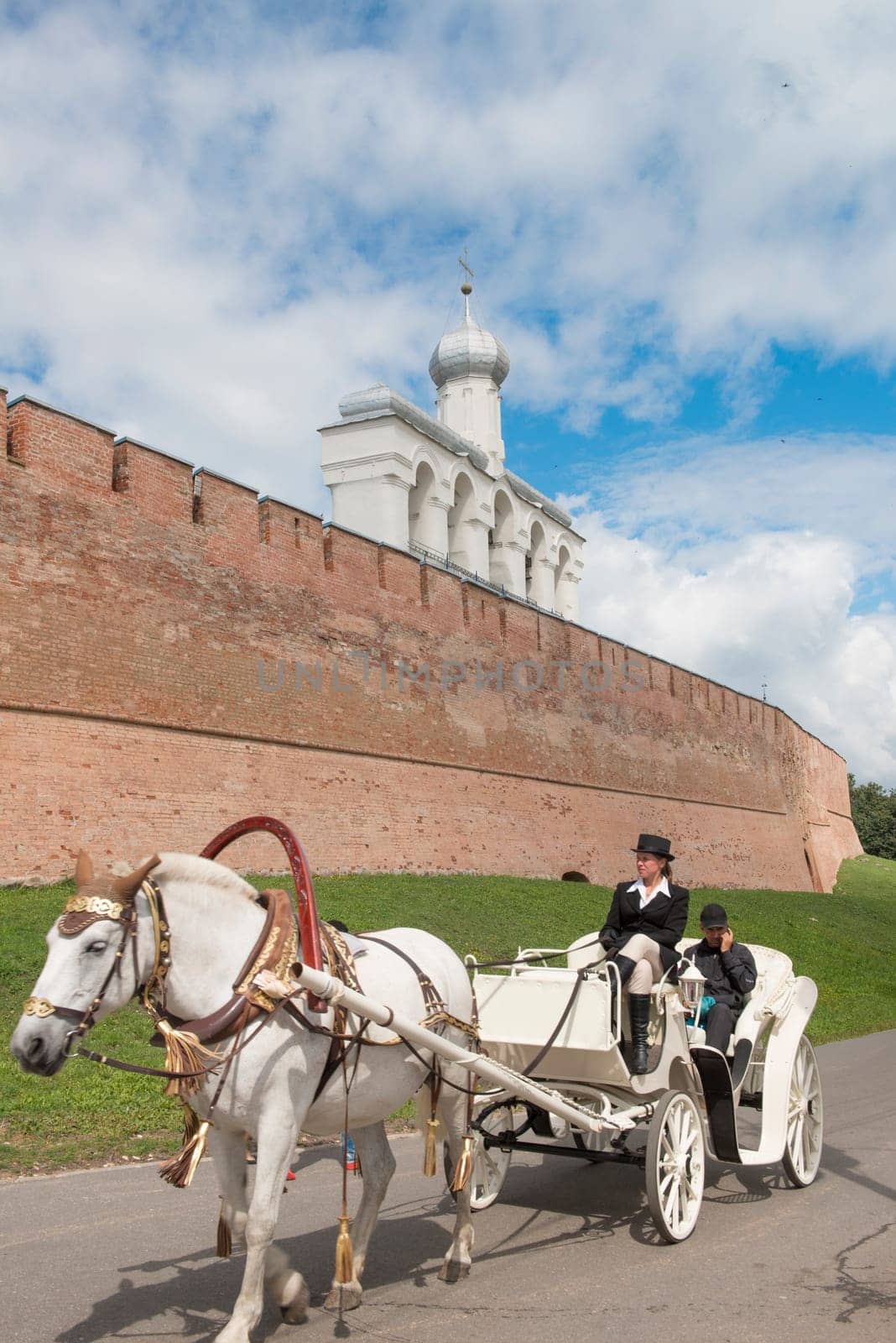 White old horse carriage is popular attraction for tourists in Novgorod.