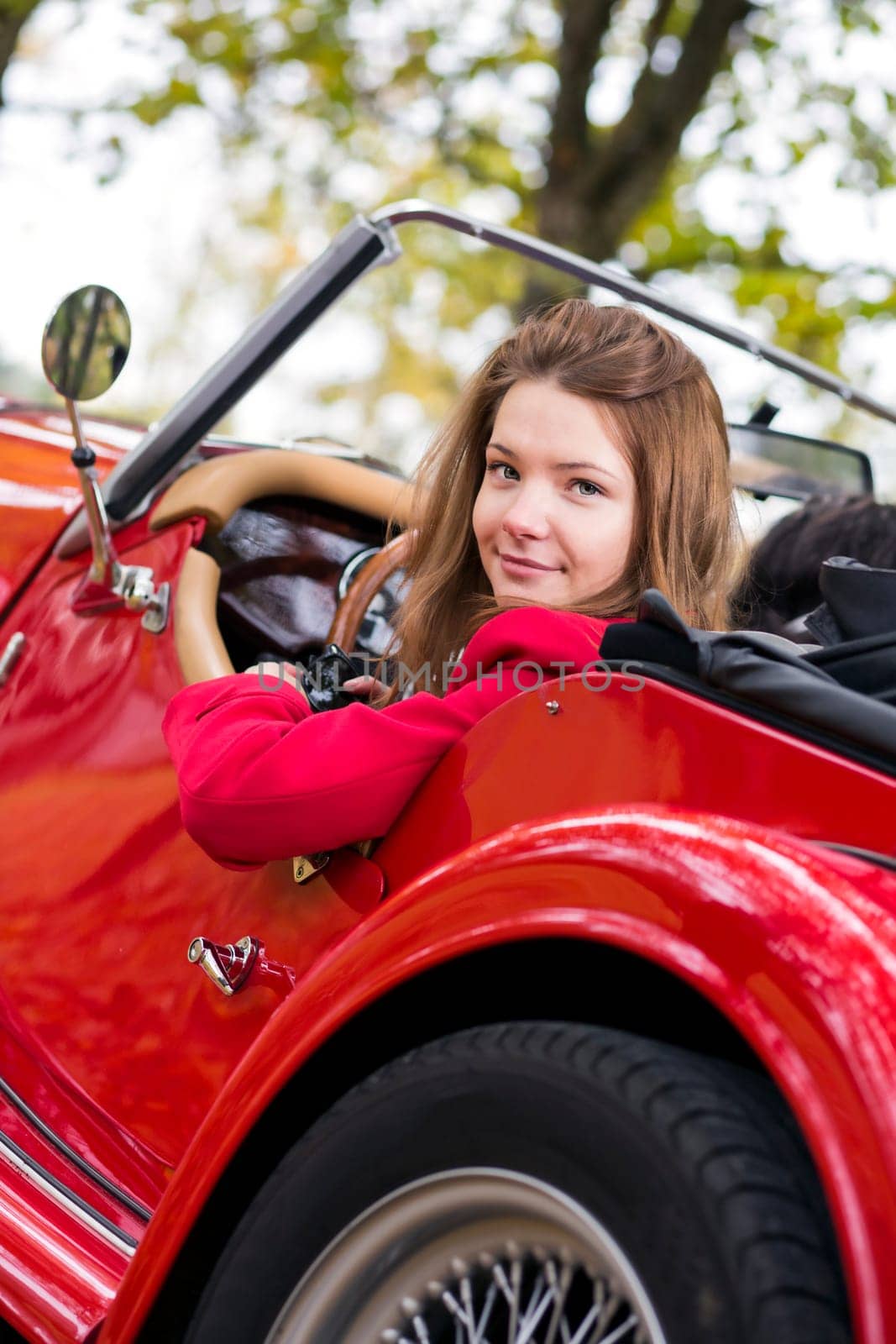 Woman sit on driver seat and look back