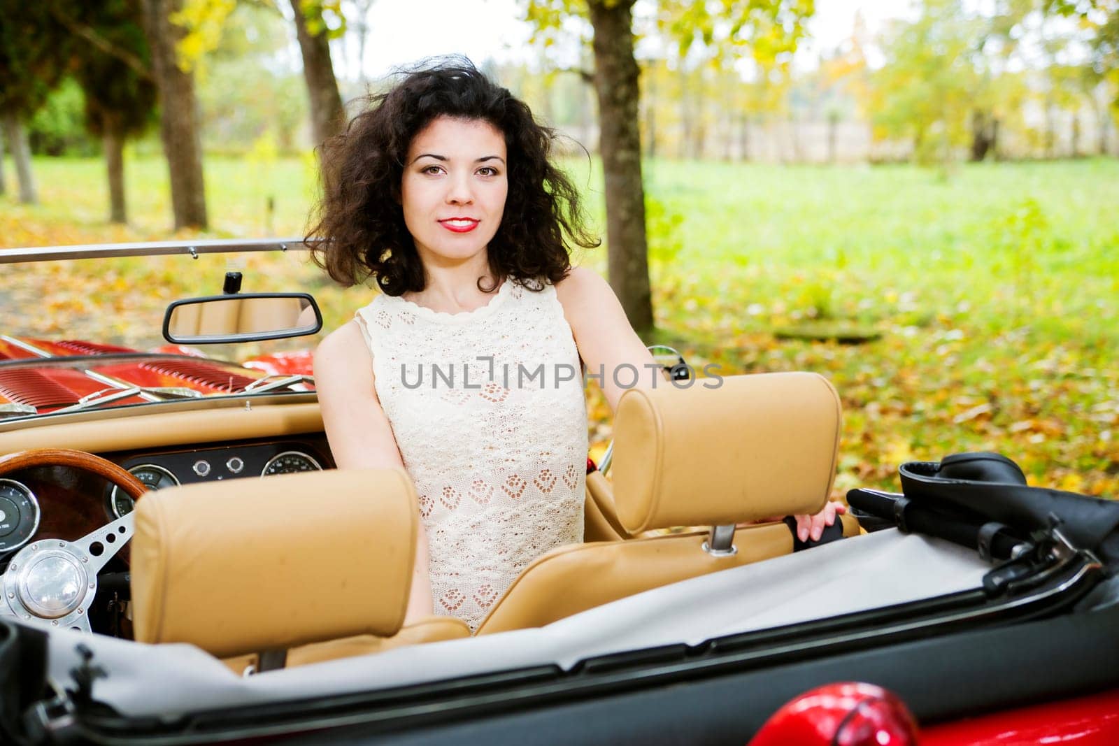 Woman at car on passanger seat at park