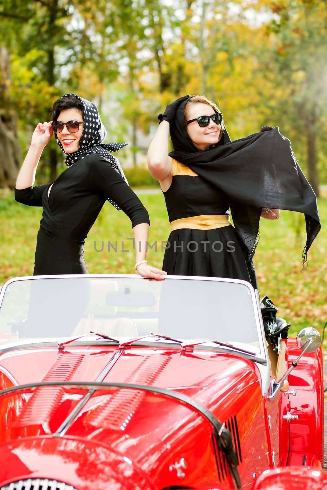 Pretty women with dark glasses standing in seats