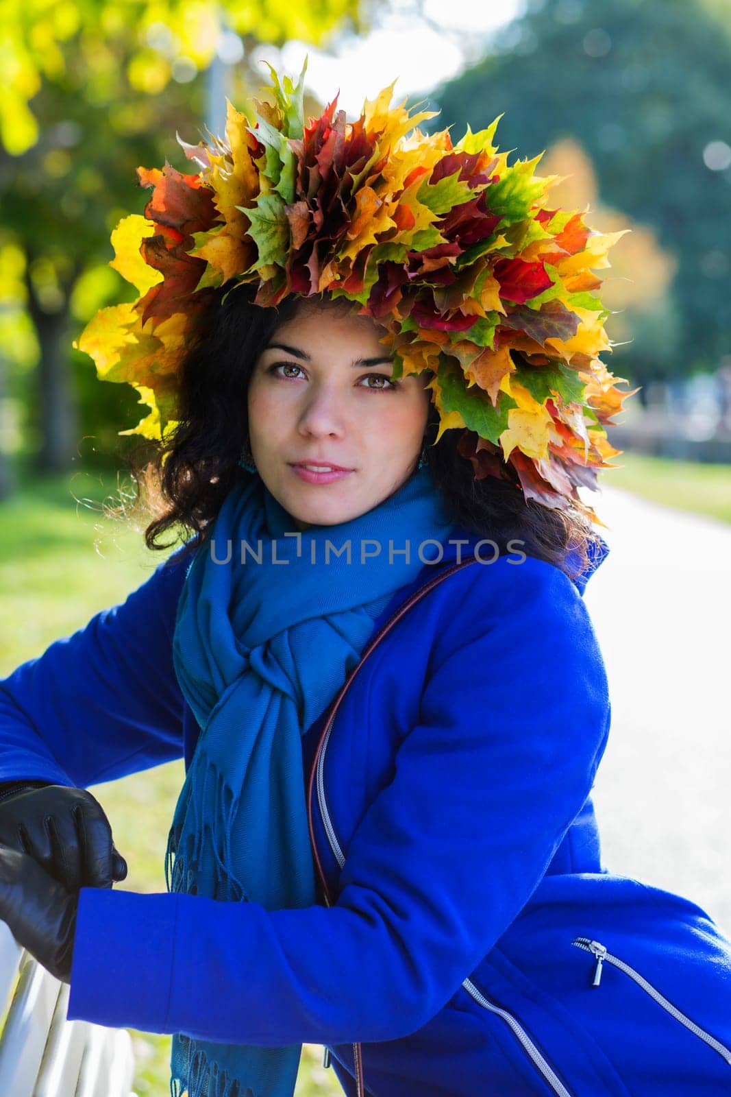 Young woman at sunny day with leaf wreath