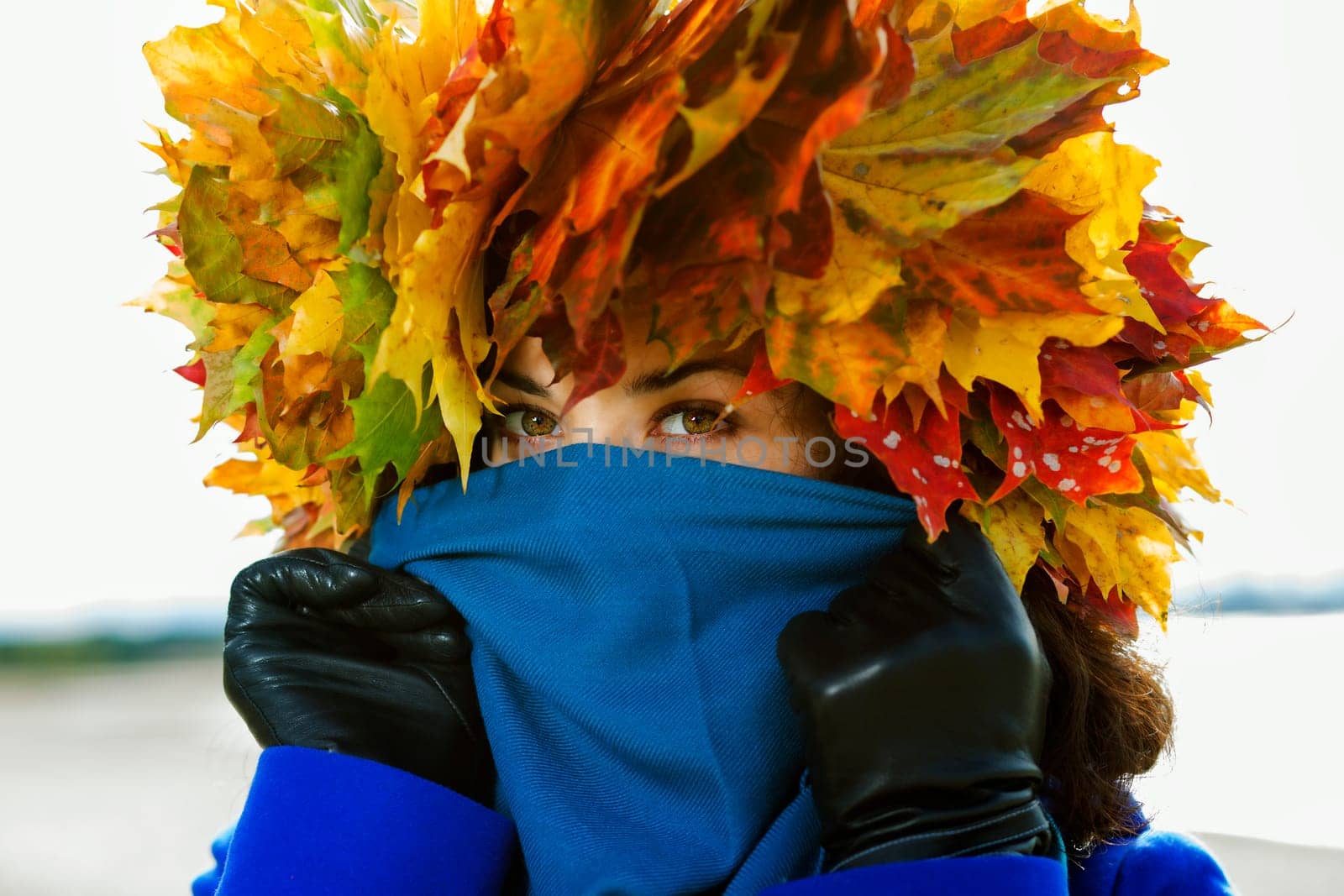 Woman hide face under scarf showing only eyes