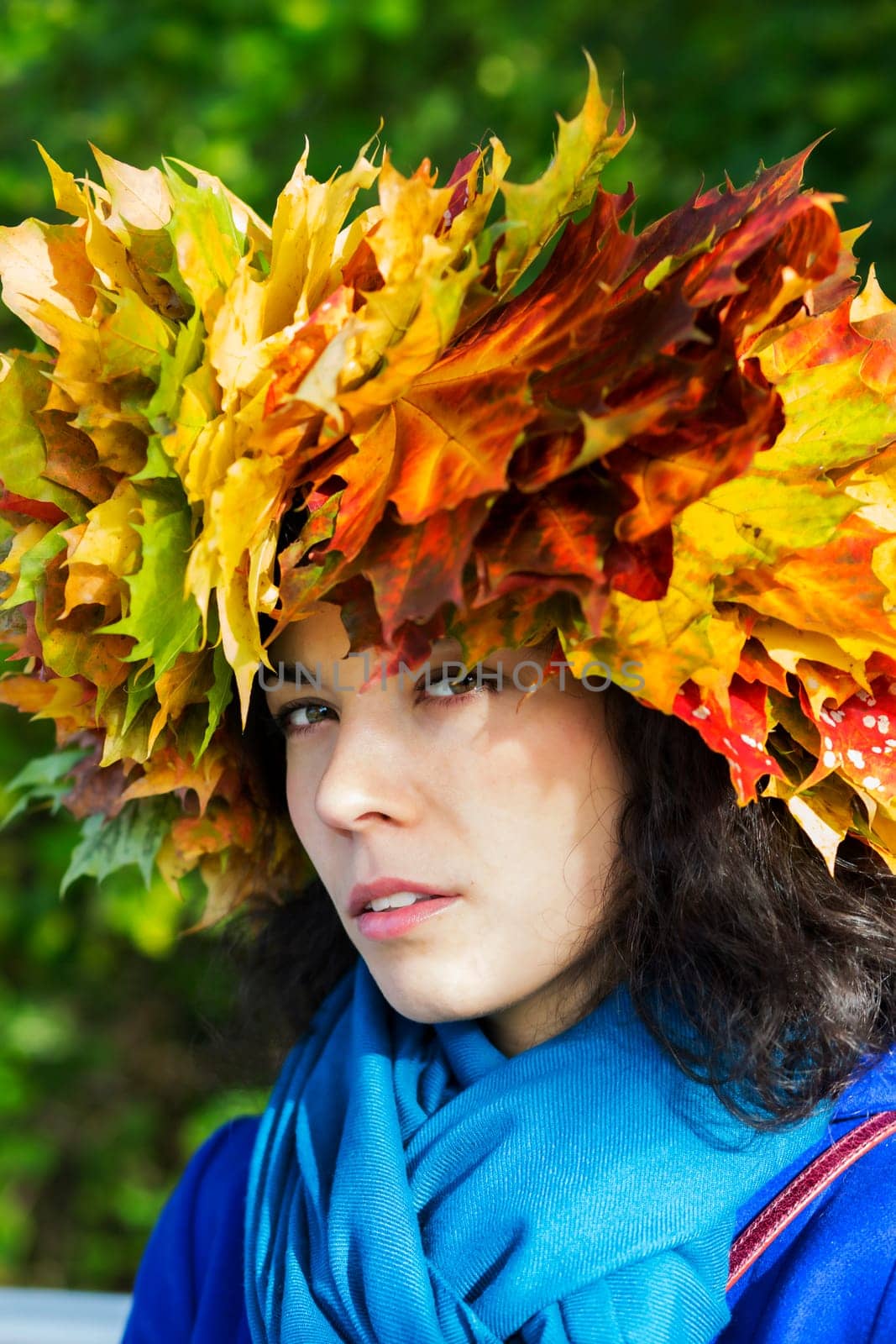 Woman with maple leaves on head look suspiciously