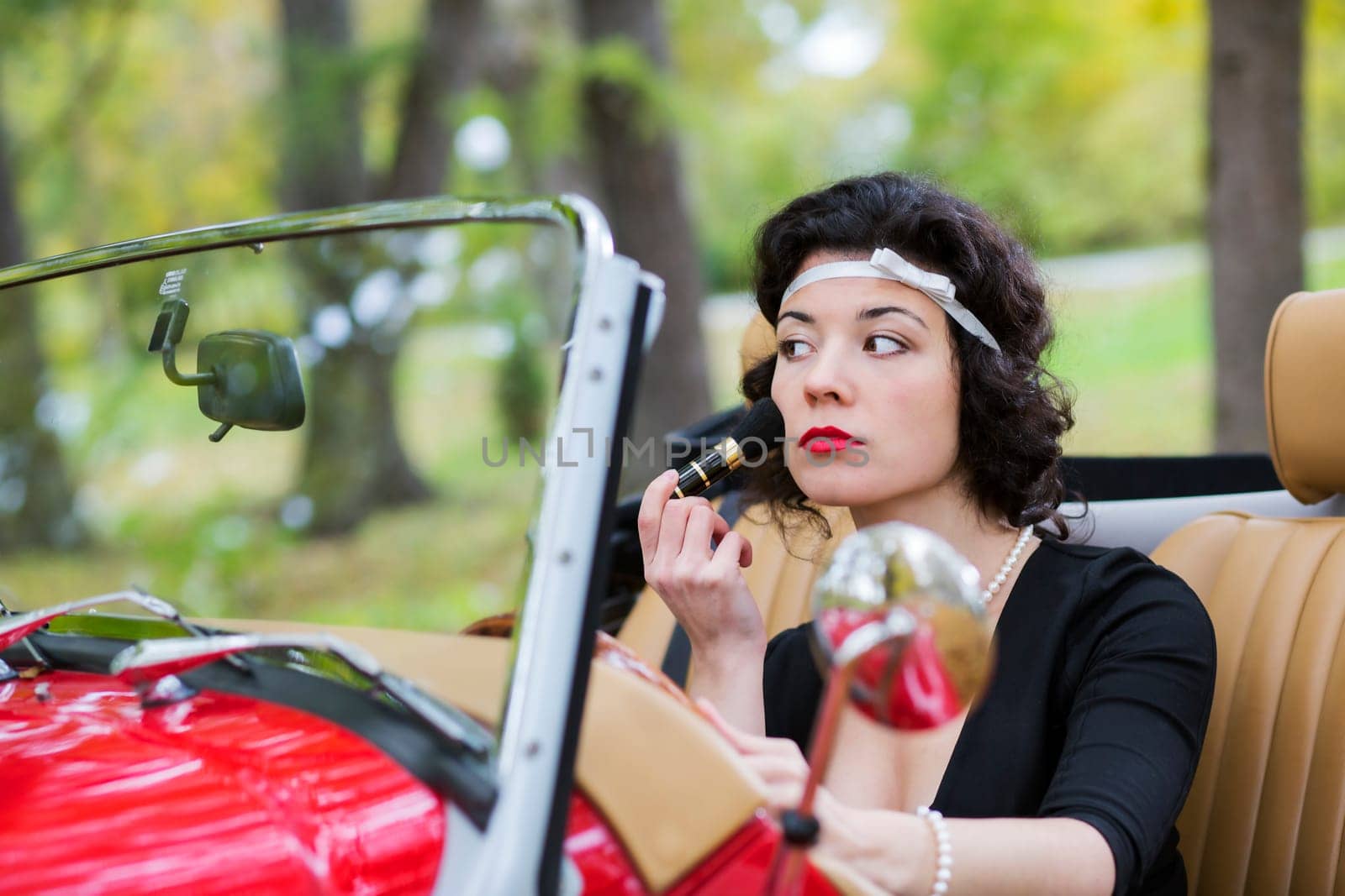 Concentrated woman adjust face before mirror with care