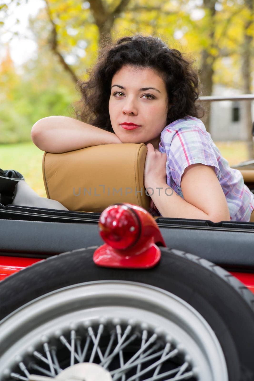 Zoomed woman relay at retro car seat back