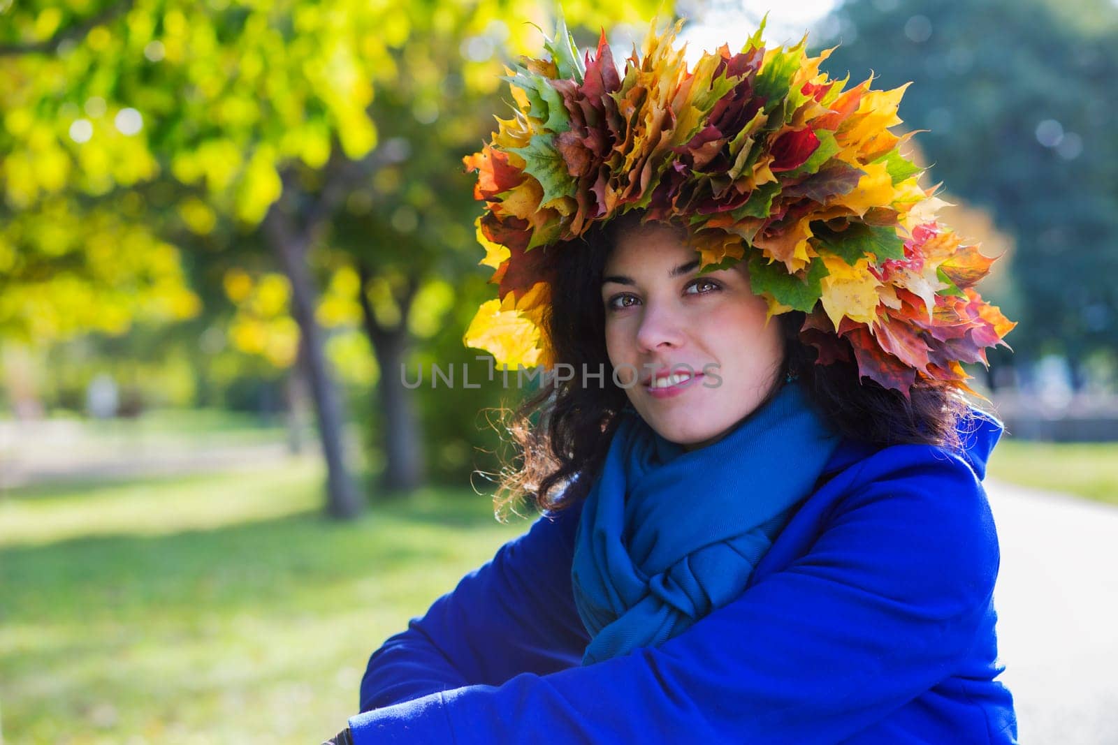 Young woman at sunny autumn day at park