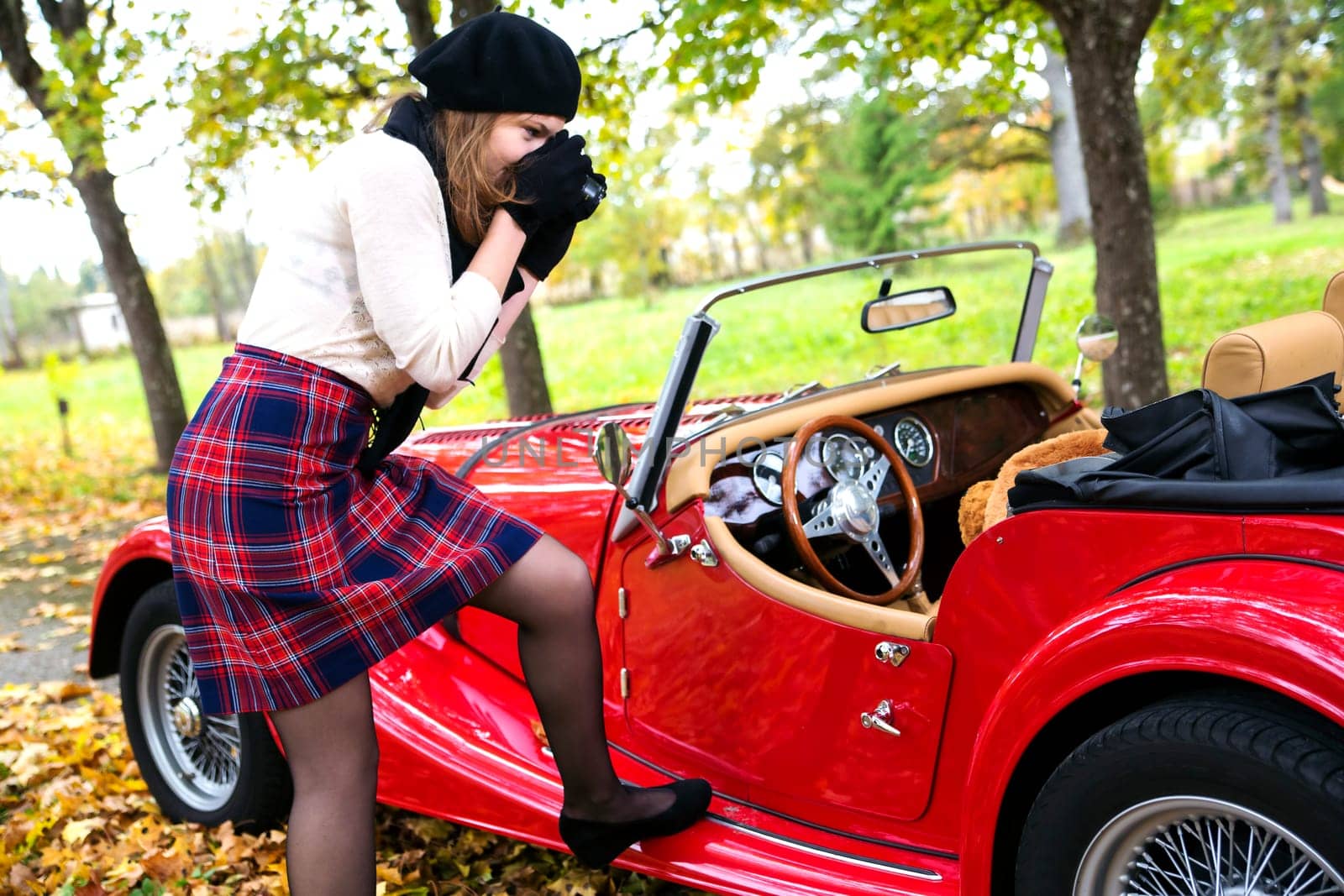 Interesting woman take photo of toy in car