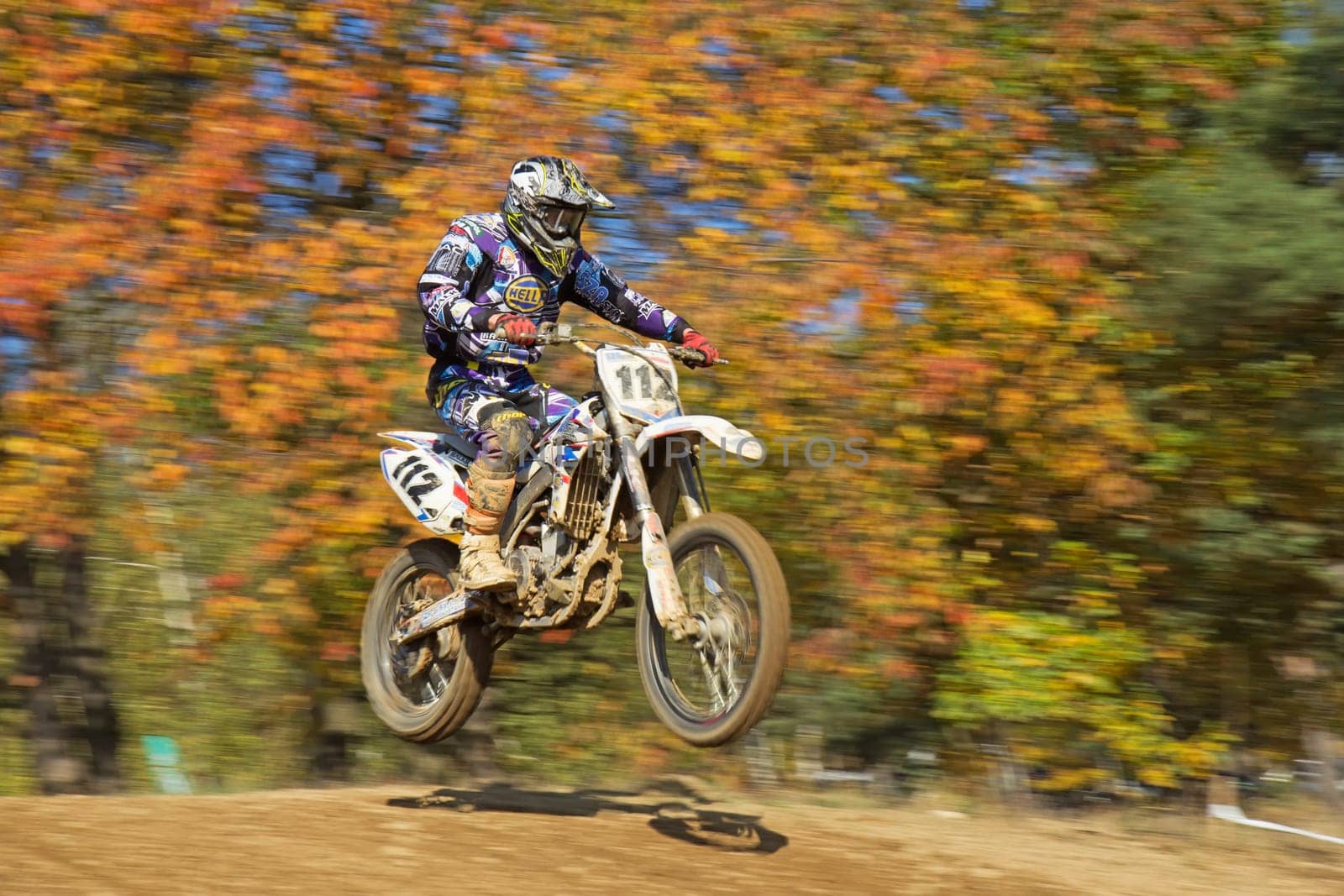 ZABREH, CZECH REPUBLIC - OCT 19. Motocross racer in blue and white is jumping at Motocross Zabreh Cup on October 19, 2013 in Zabreh, Czech Republic (Central Europe)