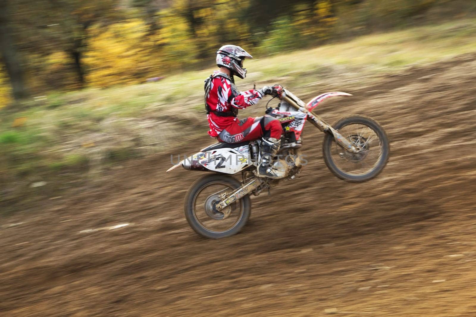 ZABREH, CZECH REPUBLIC - OCT 19.Motocross rider is going uphill. The front wheel is in the air.  Motocross Zabreh Cup on October 19, 2013 in Zabreh, Czech Republic (Central Europe)