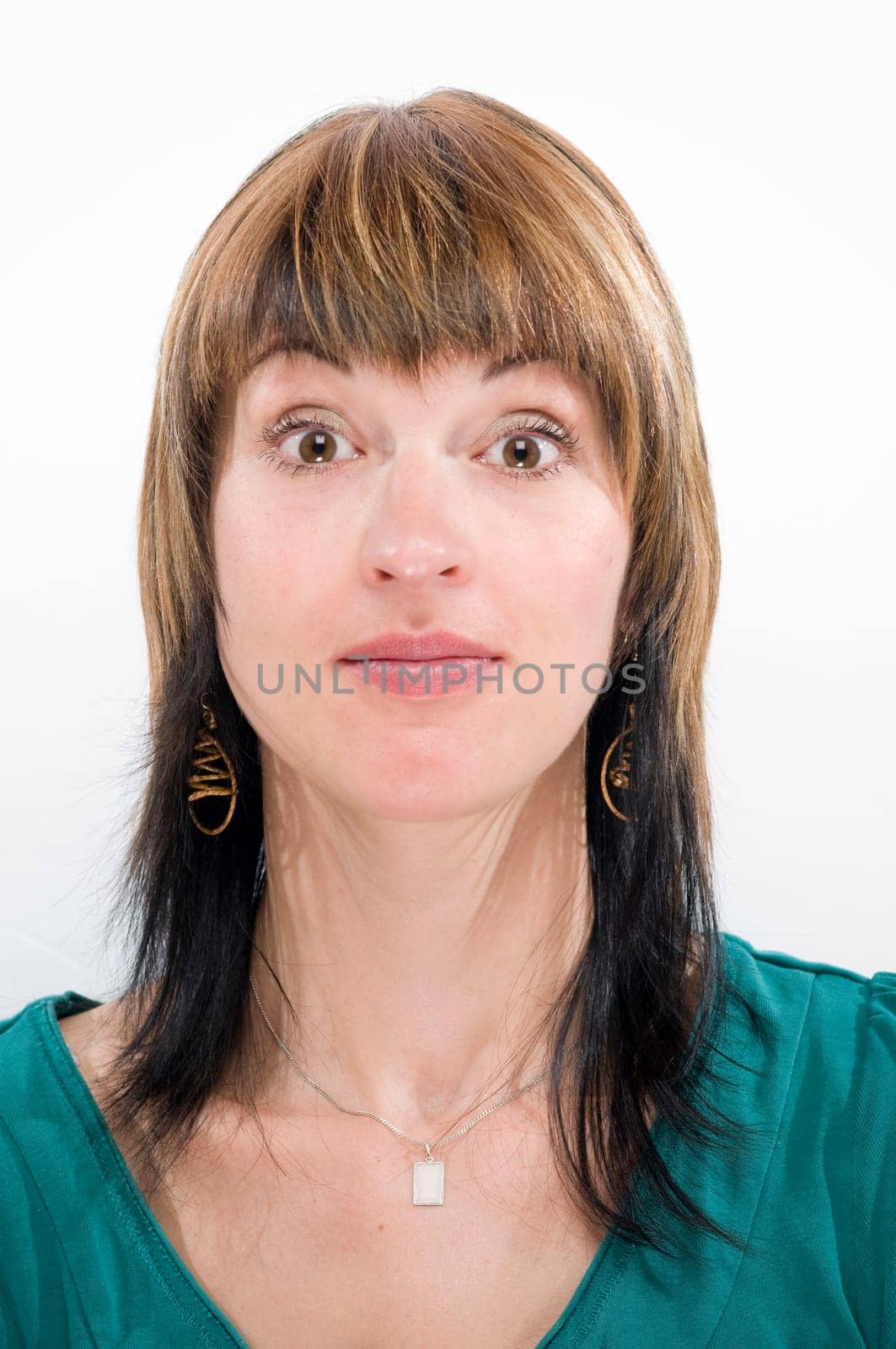 Head-and-shoulder shot of a young woman looking into the camera and a gesture of incomprehension