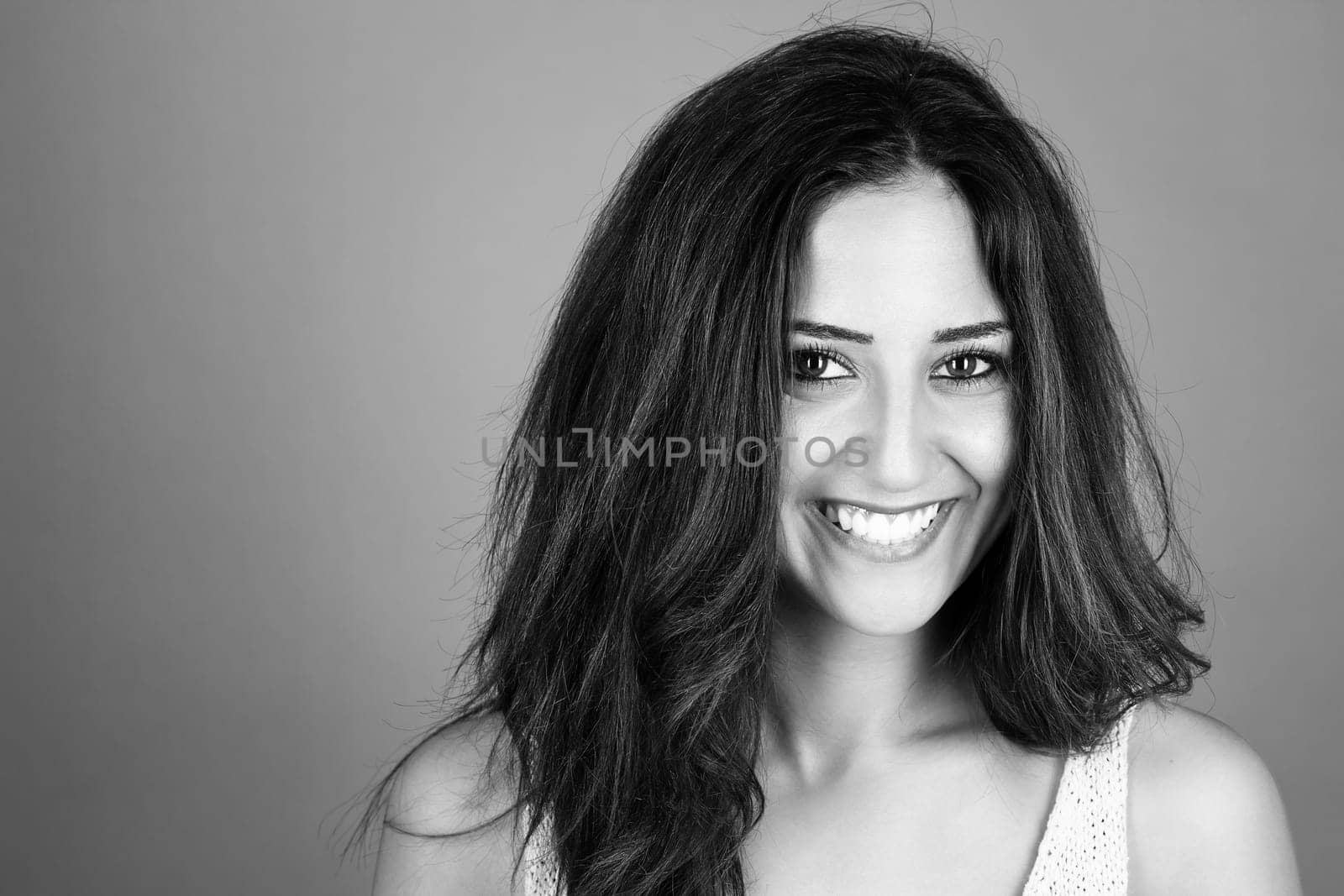 Black and white portrait of a laughing brunette young woman