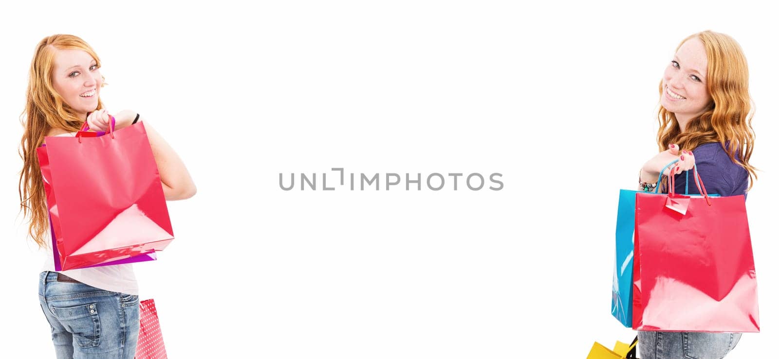 Two happy women with shopping bags and text space against a white background