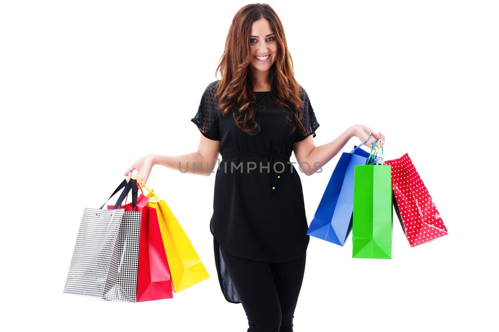 Happy laughing woman holds shopping bags against a white background