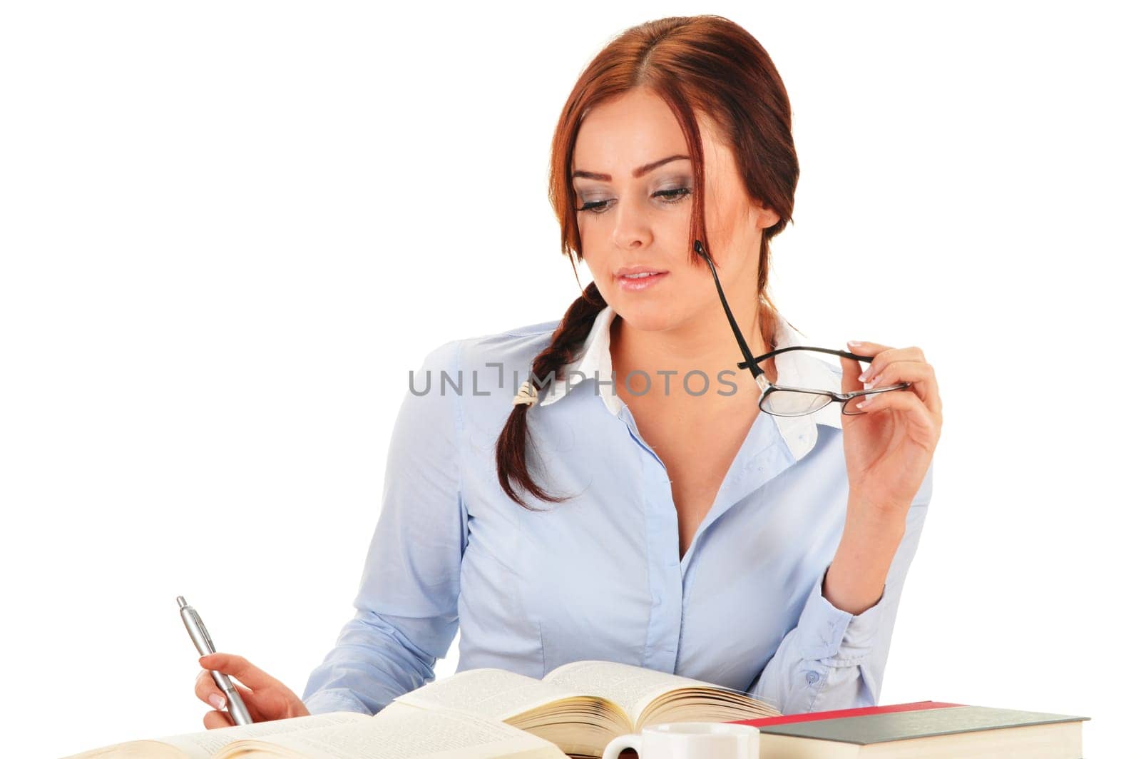 Young woman reading a book. Female student learning.