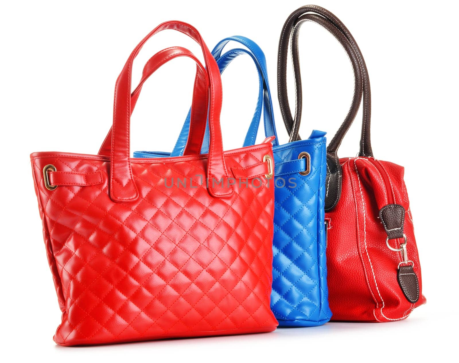Three leather handbags isolated on white background