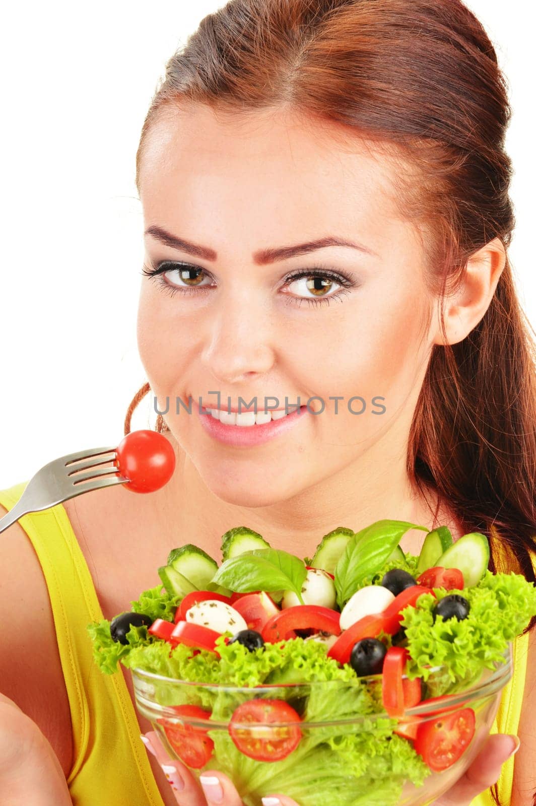 Young woman eating vegetable salad