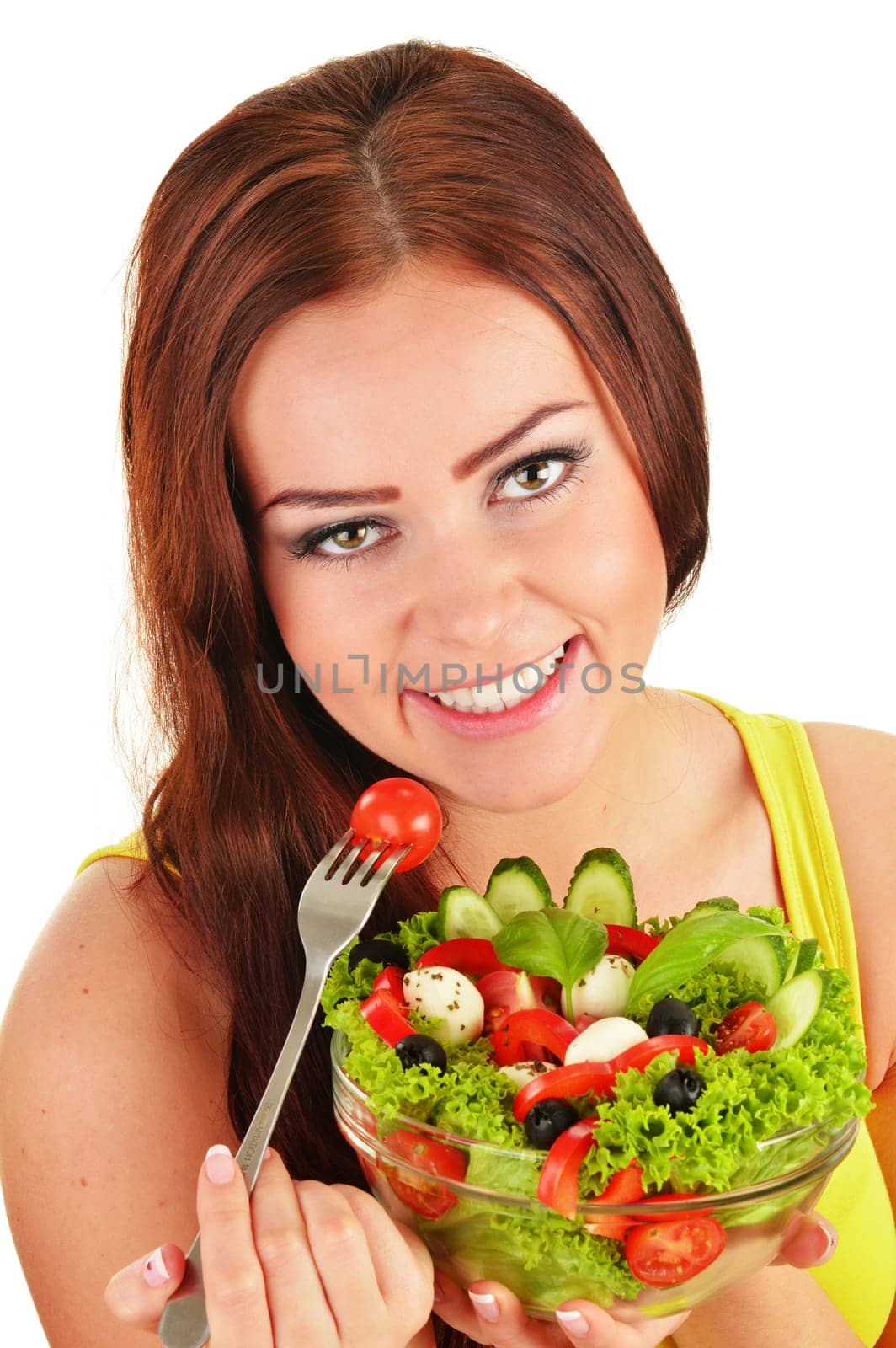 Young woman eating vegetable salad