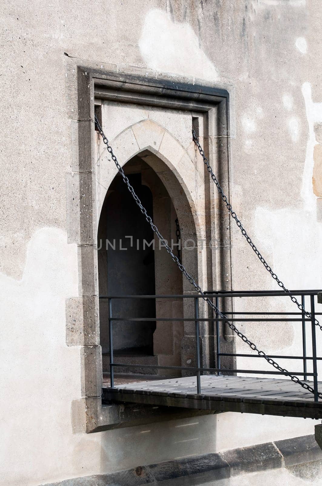 Chain driven gothic door at medieval castle in Europe.