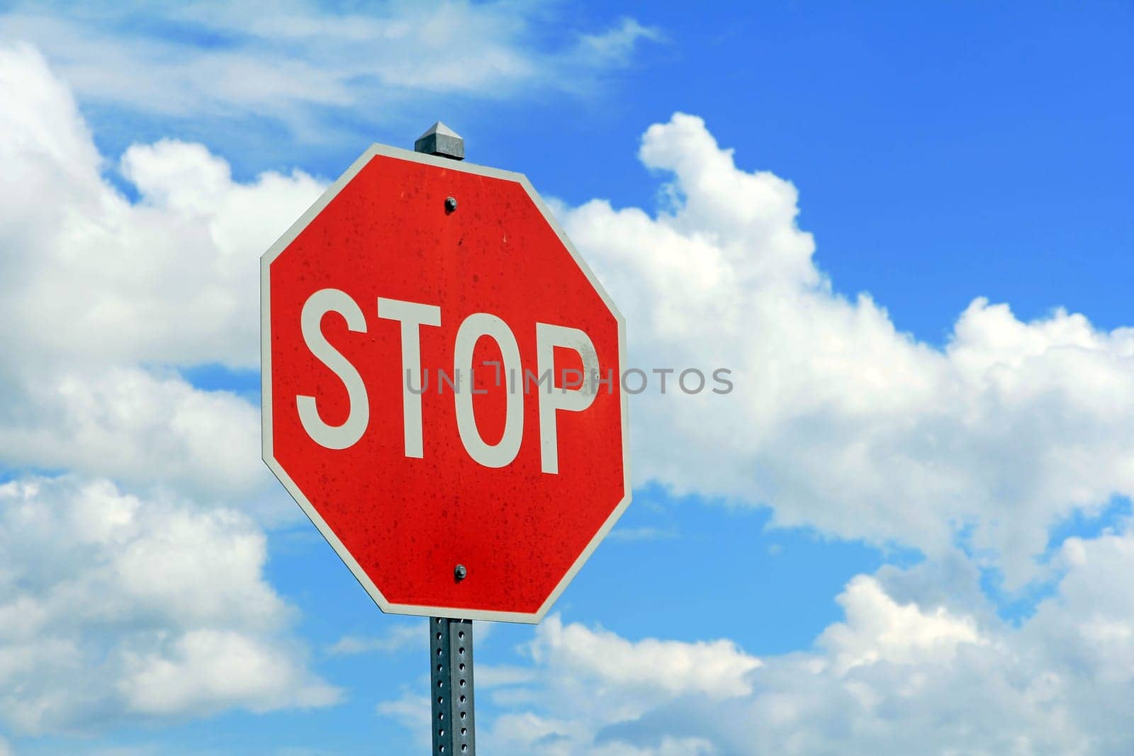 Stop sign against the blue sky