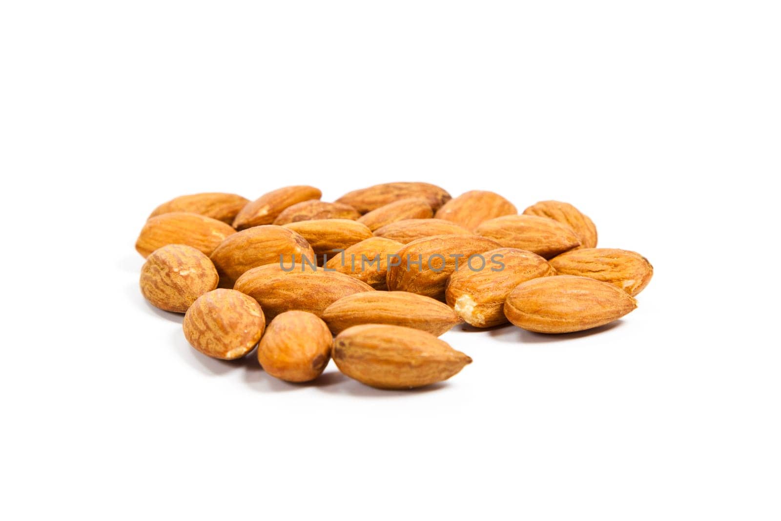 Heap of almond nuts isolated on white background