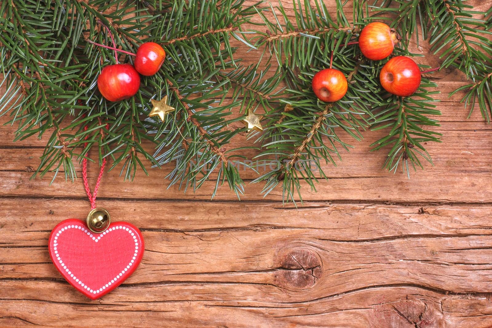 Fir branches with apples and heart pendants