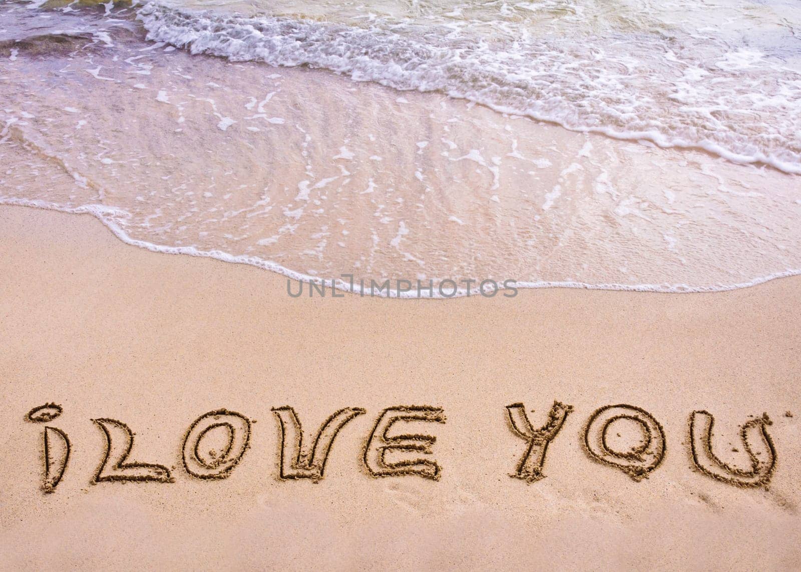 words I Love You written on sand, love concept