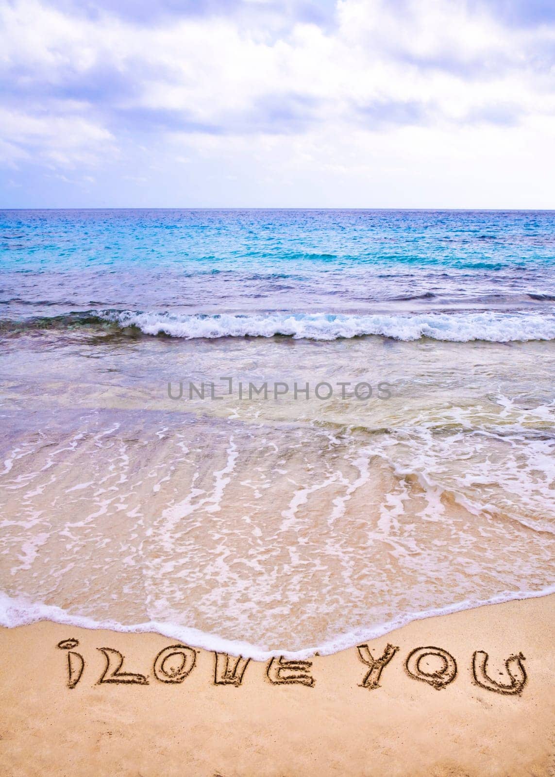 words I Love You written on sand, love concept