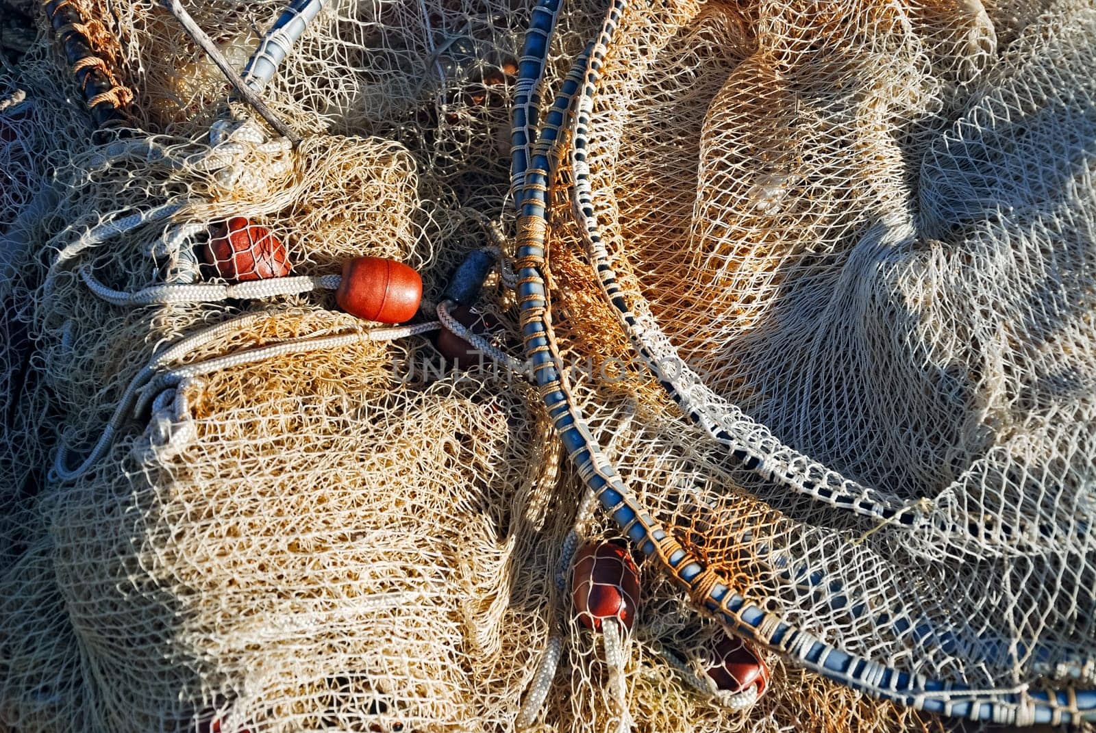 Fishing net with float lies on the quay to dry