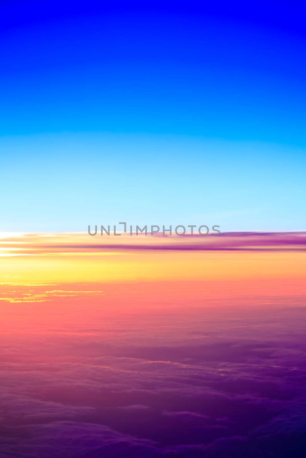 sunset with a height of 10 000 km. Dramatic sunset. View of sunset above clouds from airplane window