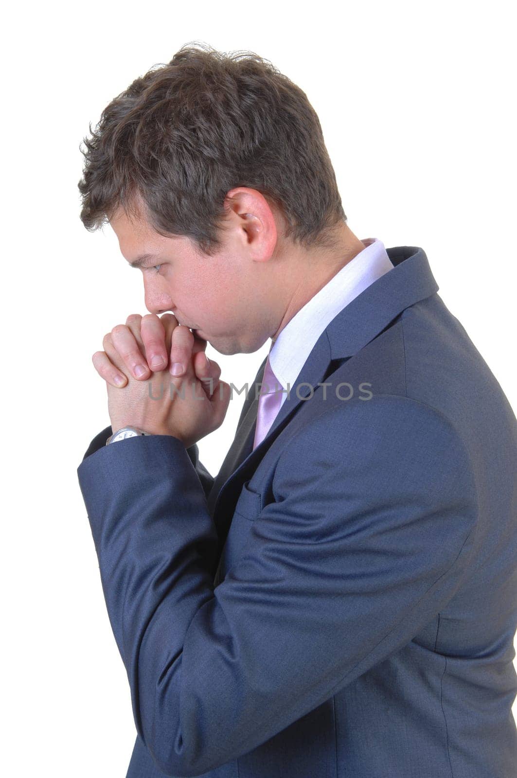 A young businessman praying for a big decision for white background.in a blue suit..