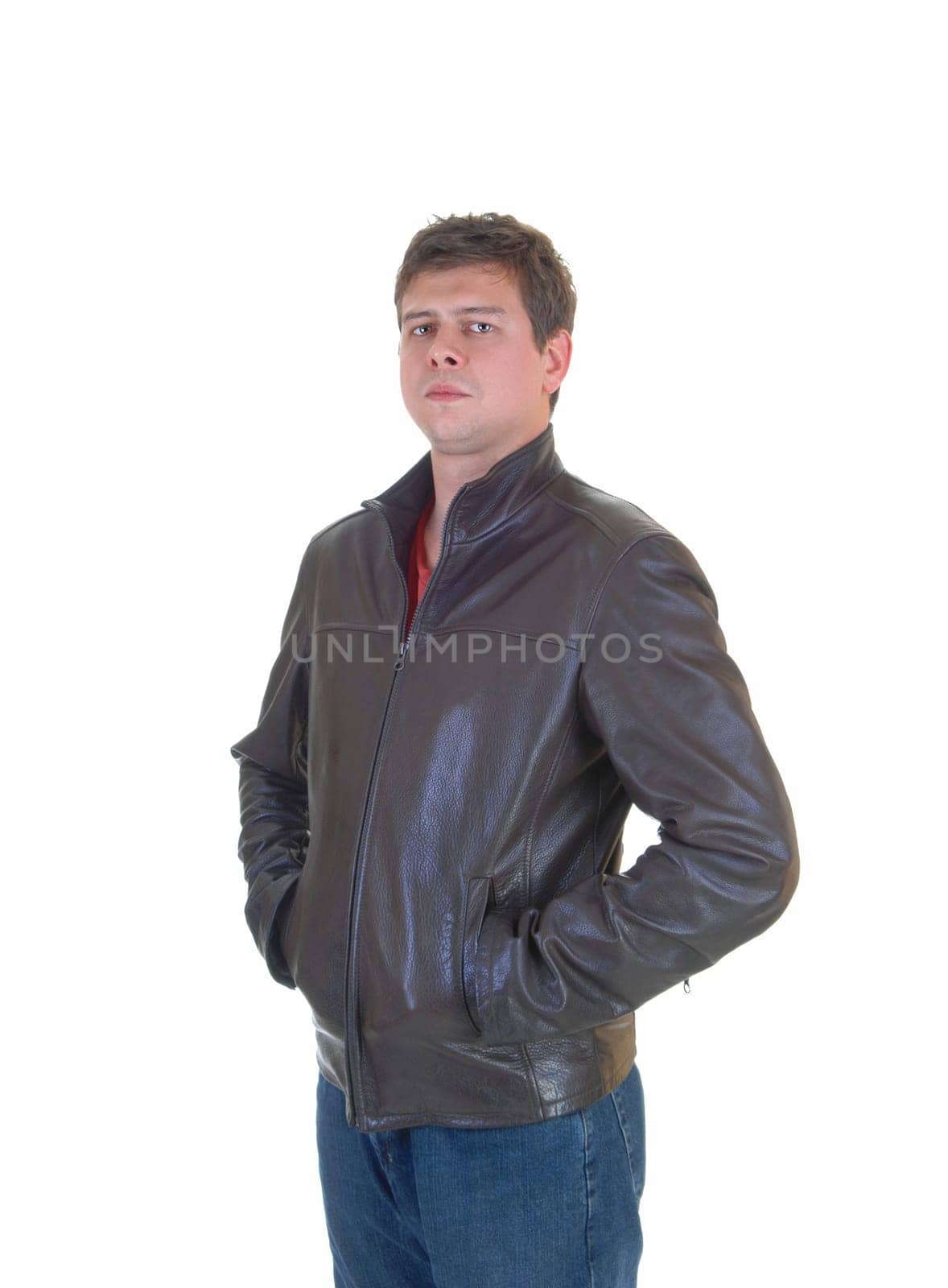 A young handsome man in a brown leather jacket and jeans standing for.white background..