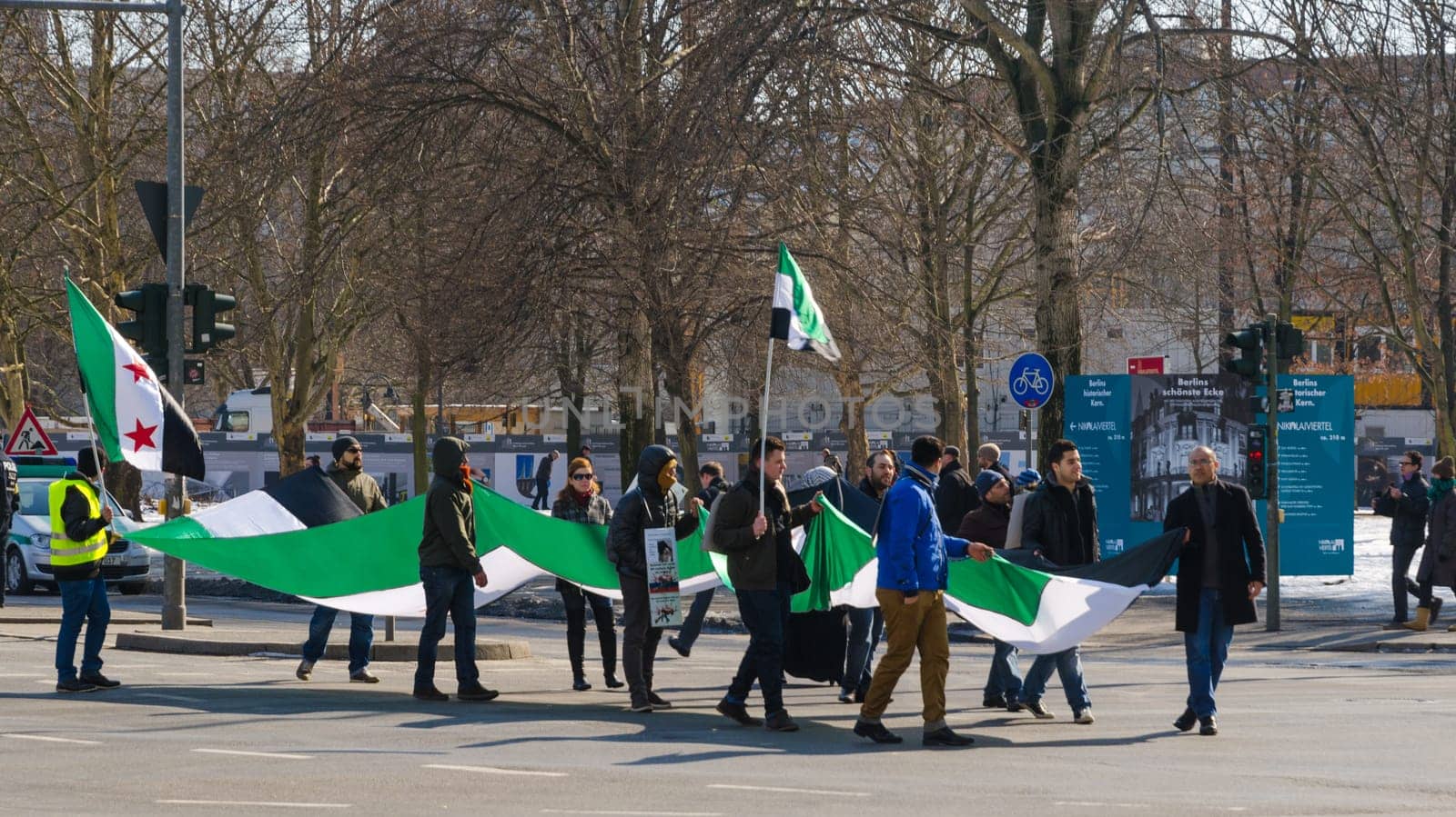 Pro-opposition protesters activists carrying the Syrian flag on demonstration against ruling regime of Bashar al-Assad.