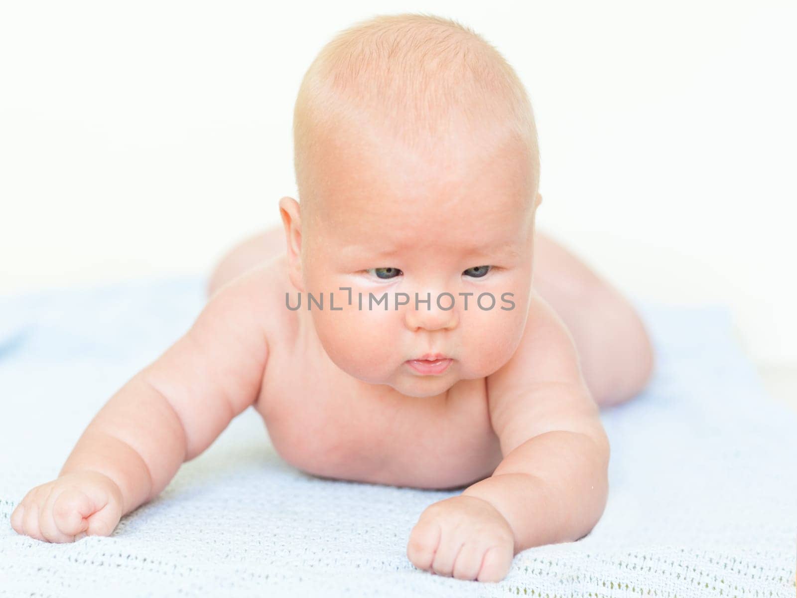 Cute baby laying on the blue towel