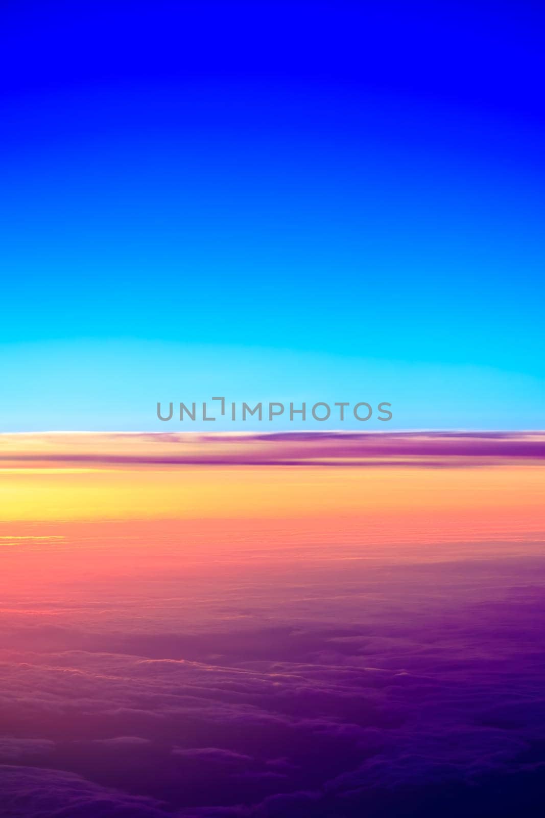 sunset with a height of 10 000 km. Dramatic sunset. View of sunset above clouds from airplane window