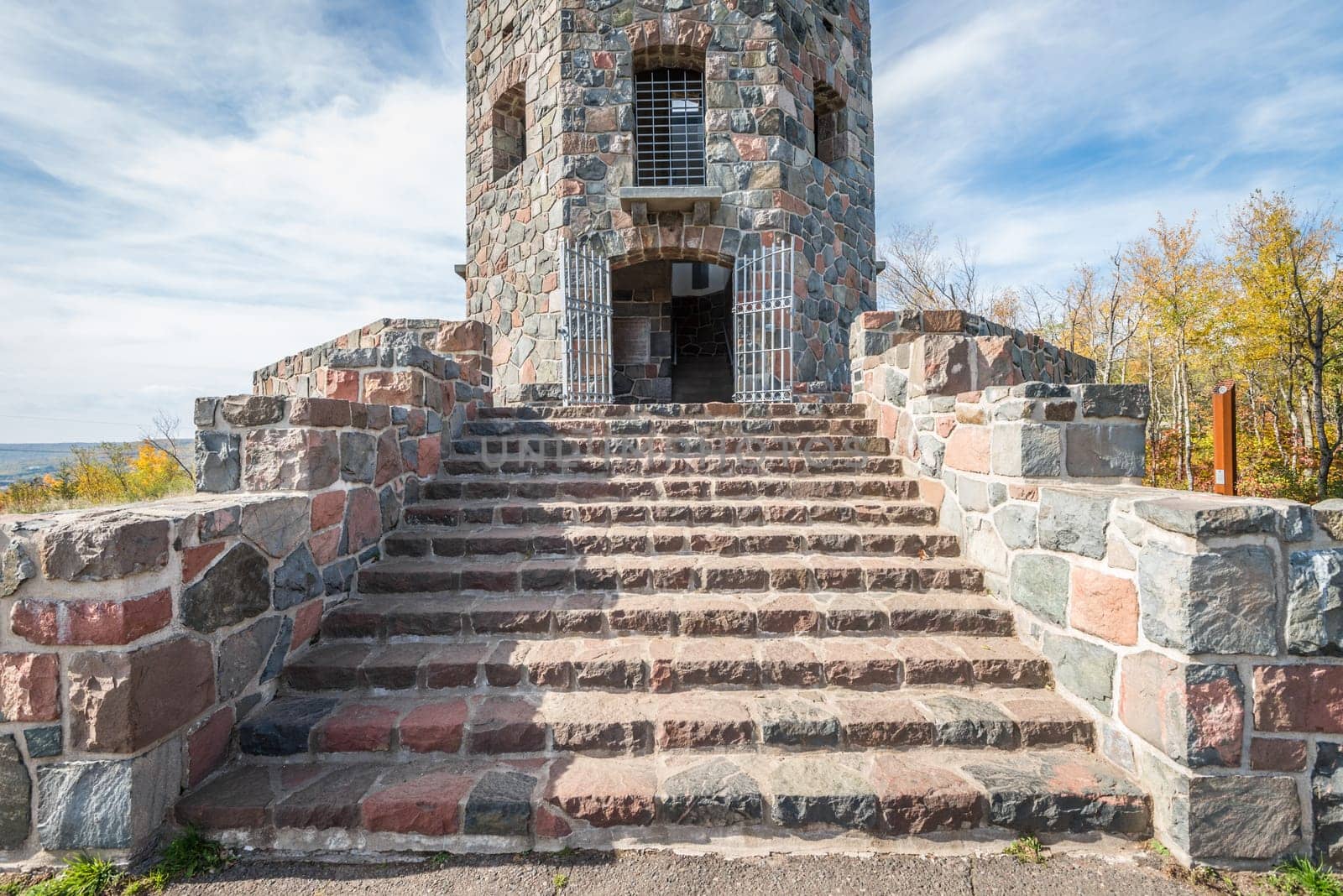 Front entrace of a stone tower during autumn time