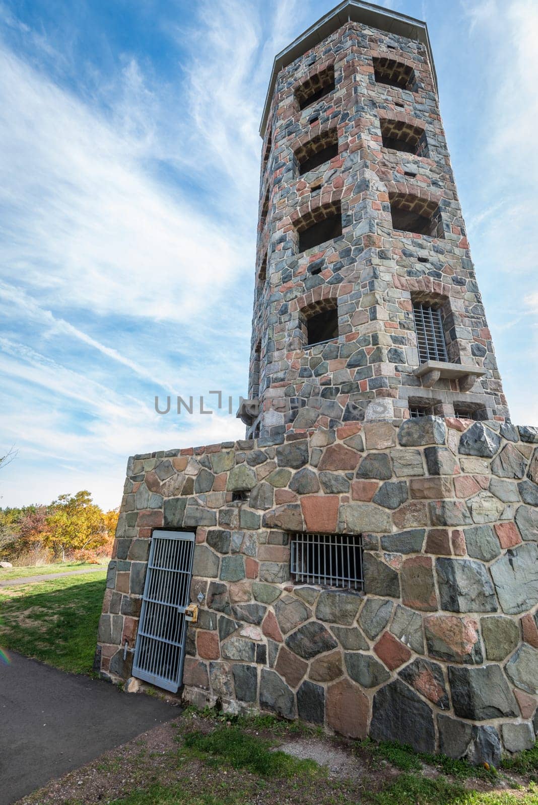 Stone tower in middle of a public park during autumn